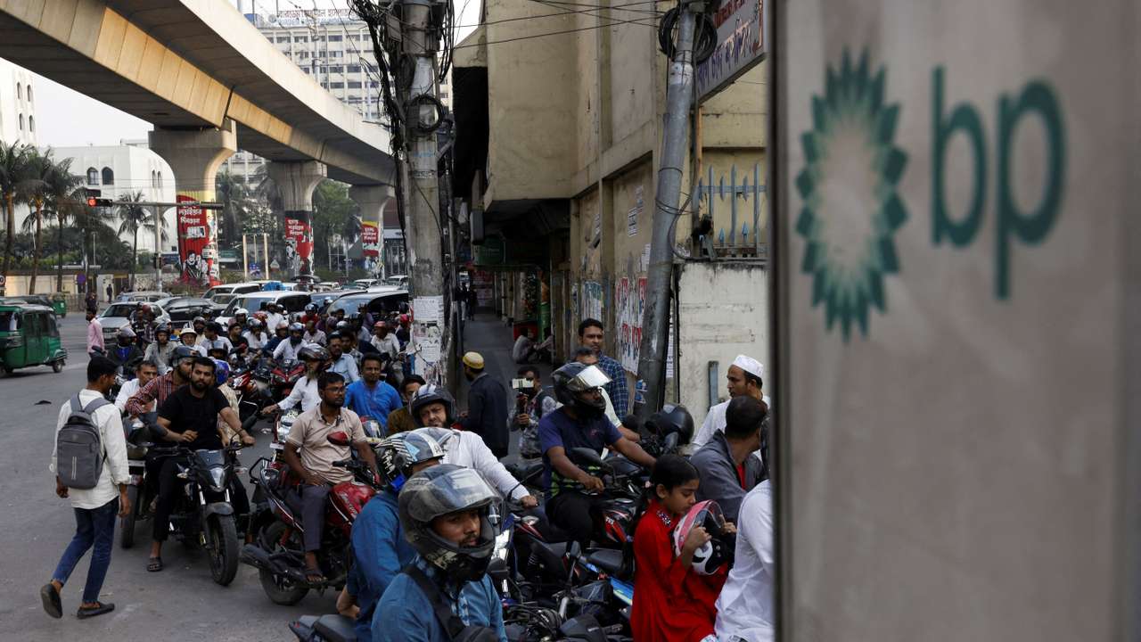 FILE PHOTO: Vehicles queue at a fuel station, as concerns grow over fuel supplies following U.S.-Israel conflict with Iran, in Dhaka