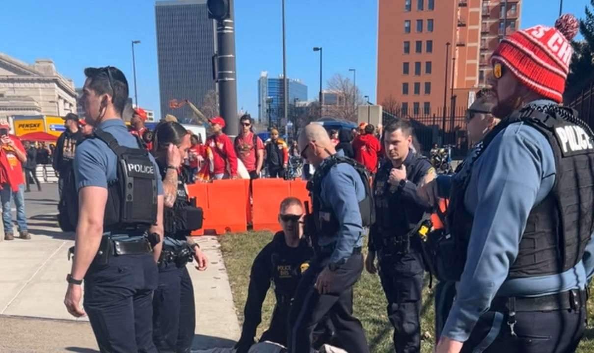 Police detain a person following a shooting near an outdoor celebration of the NFL champion Chiefs' Super Bowl victory, in Kansas City