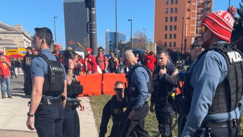 Police detain a person following a shooting near an outdoor celebration of the NFL champion Chiefs' Super Bowl victory, in Kansas City