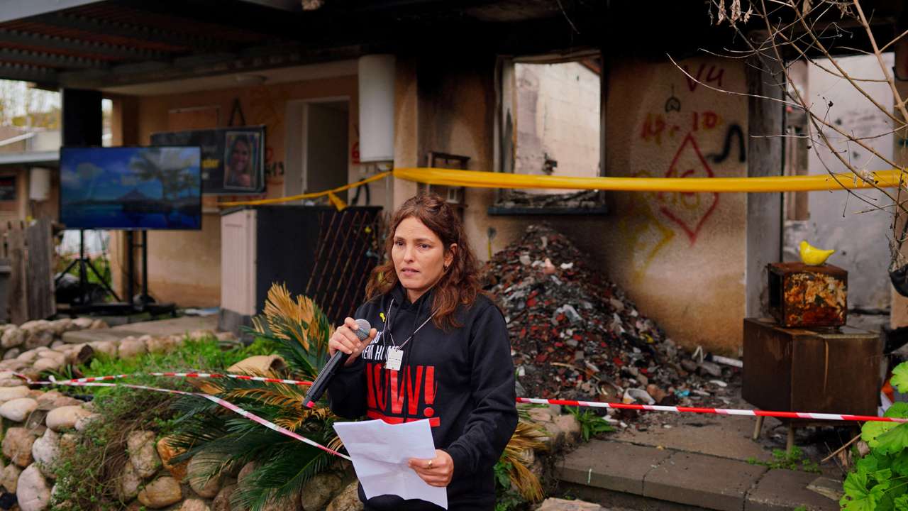 Released hostage Amit Soussana talks to the press in front of her destroyed home at the Kibbutz Kfar Aza
