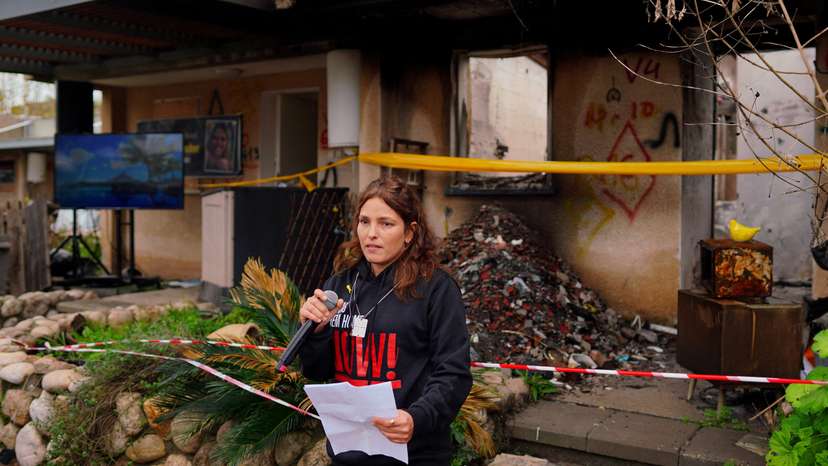 Released hostage Amit Soussana talks to the press in front of her destroyed home at the Kibbutz Kfar Aza