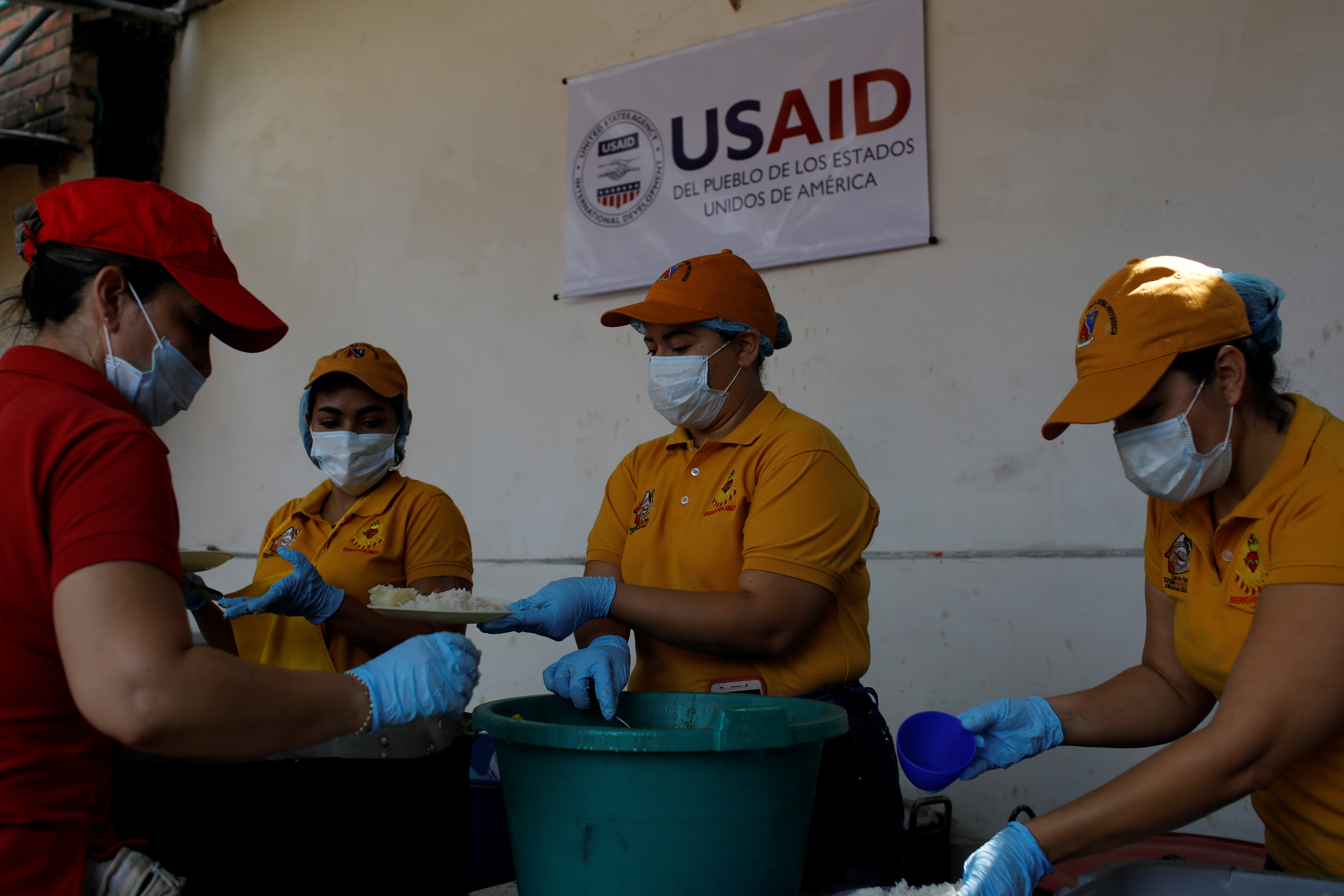 Volunteers serve lunch at a community kitchen set-up by USAID and World Food Programme in Cucuta