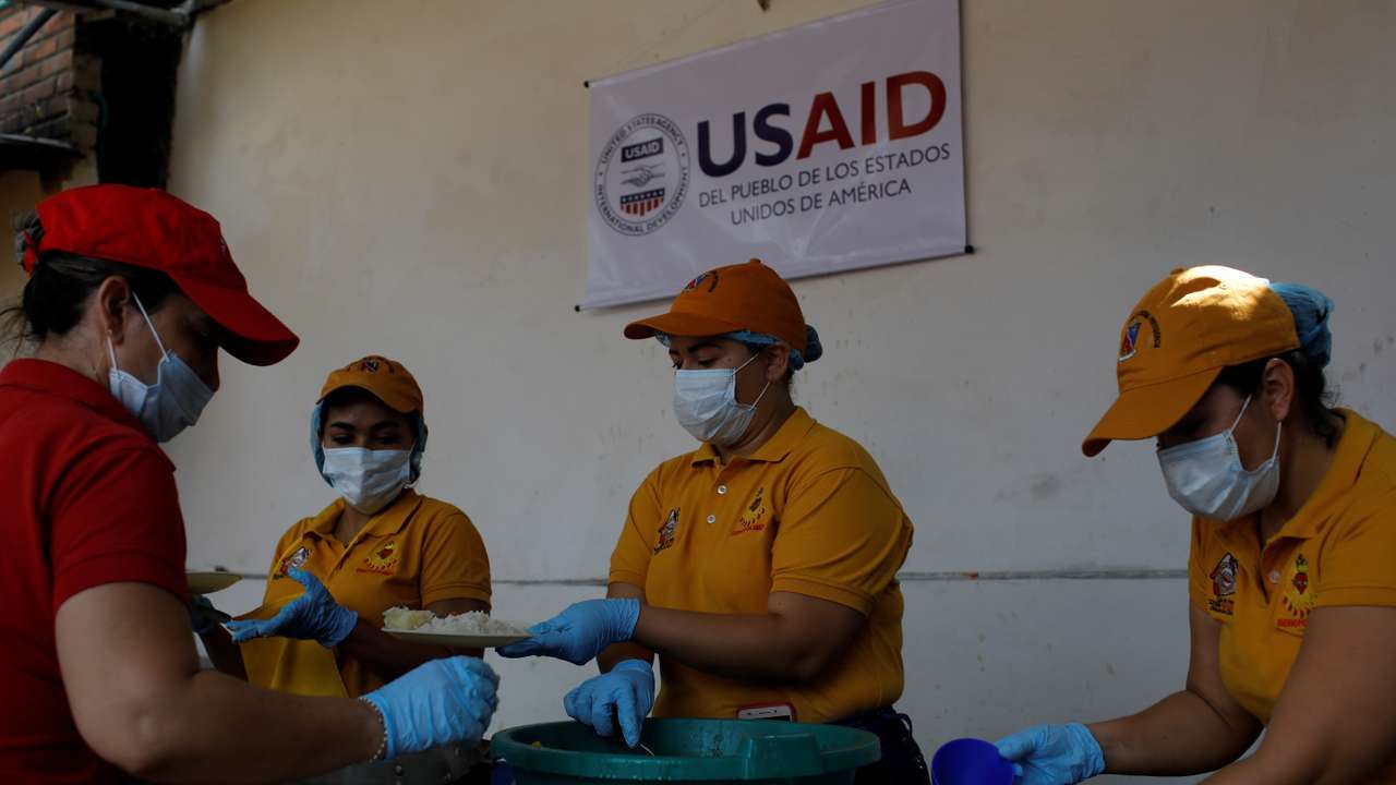 Volunteers serve lunch at a community kitchen set-up by USAID and World Food Programme in Cucuta