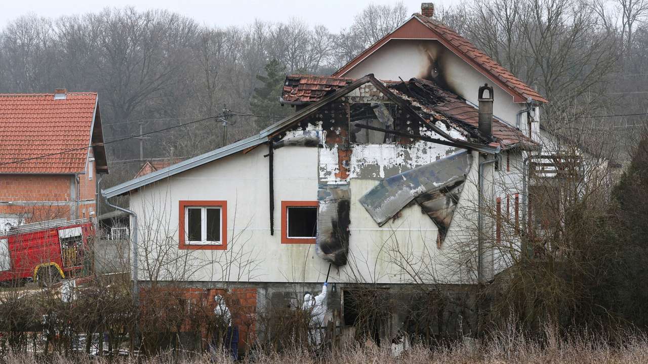 FILE PHOTO: Emergency personnel work at a damaged nursing home that caught fire, outside Belgrade