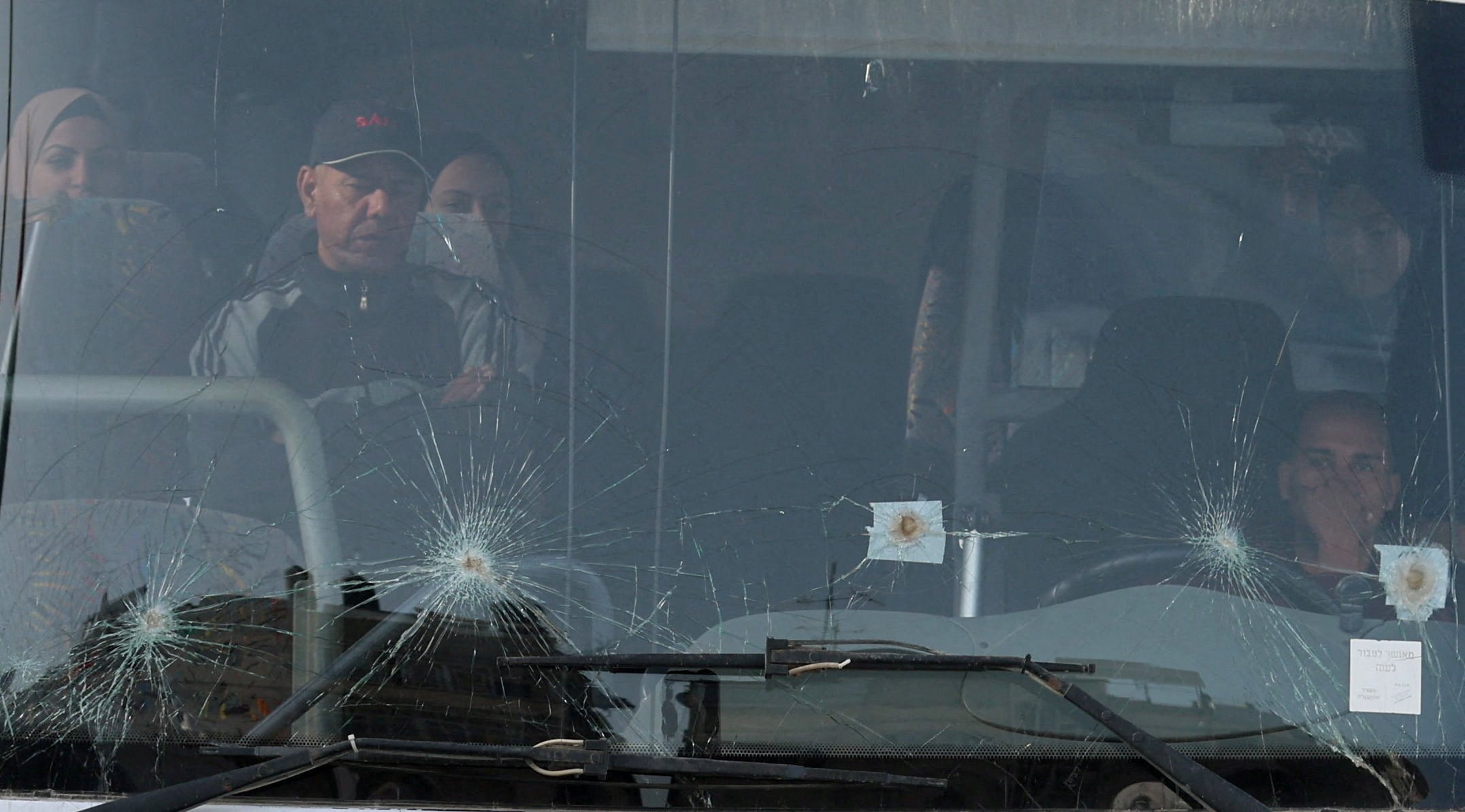 Palestinians sit in a bus as they get ready to leave Gaza through the Rafah border crossing, in the southern Gaza Strip