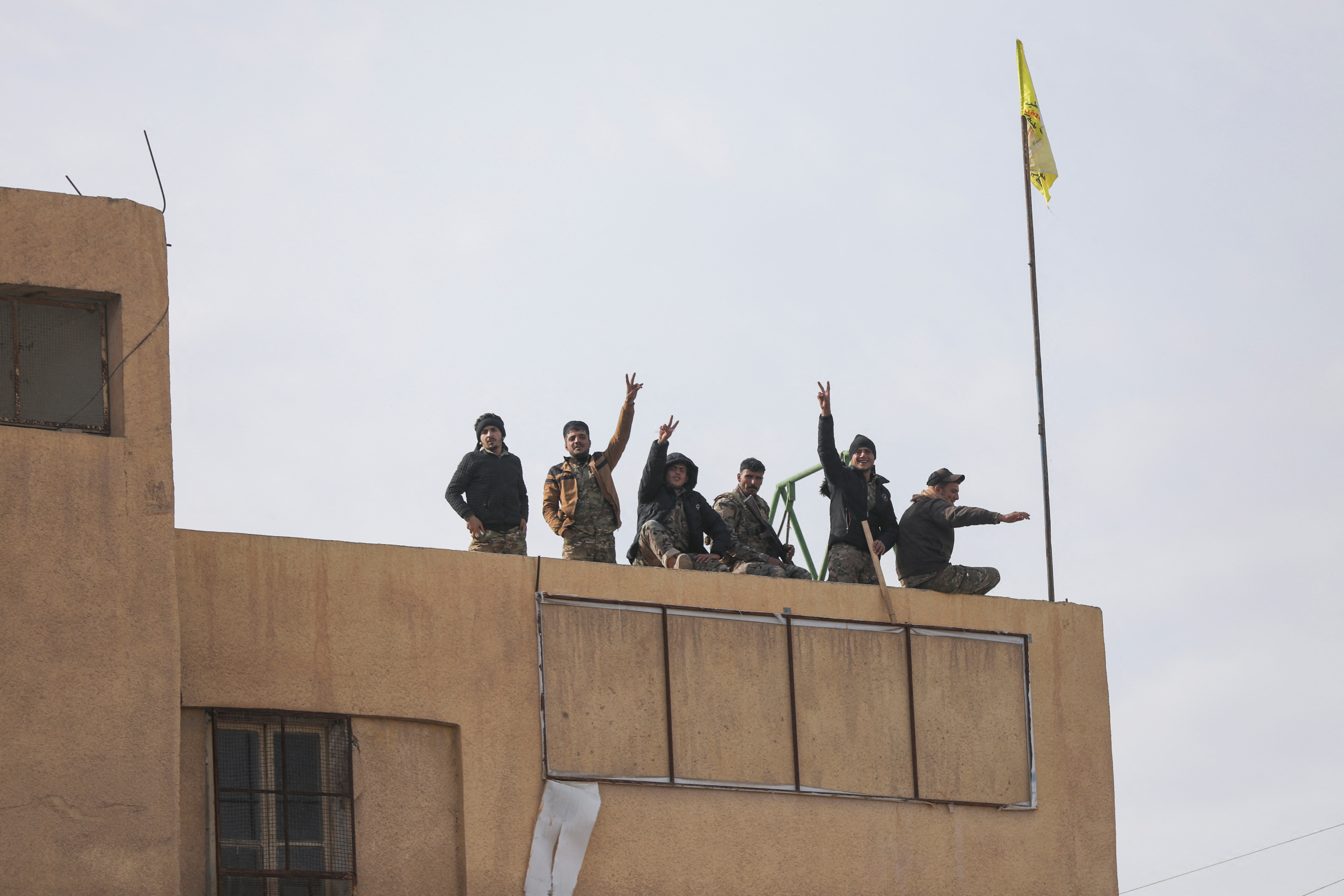 Members of the Kurdish-led Syrian Democratic Forces (SDF) gesture in Deir al-Zor