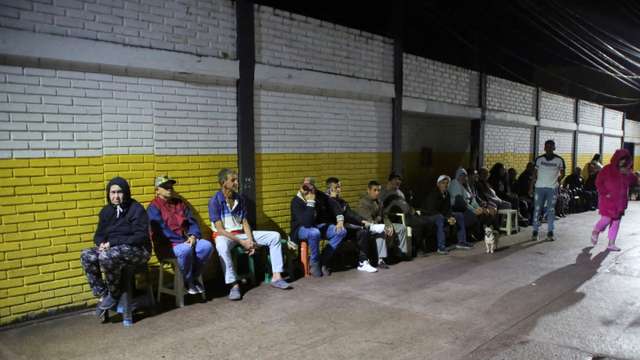 Venezuelans wait outside a closed voting station to vote in the presidential election, in Las Vegas de Tariba