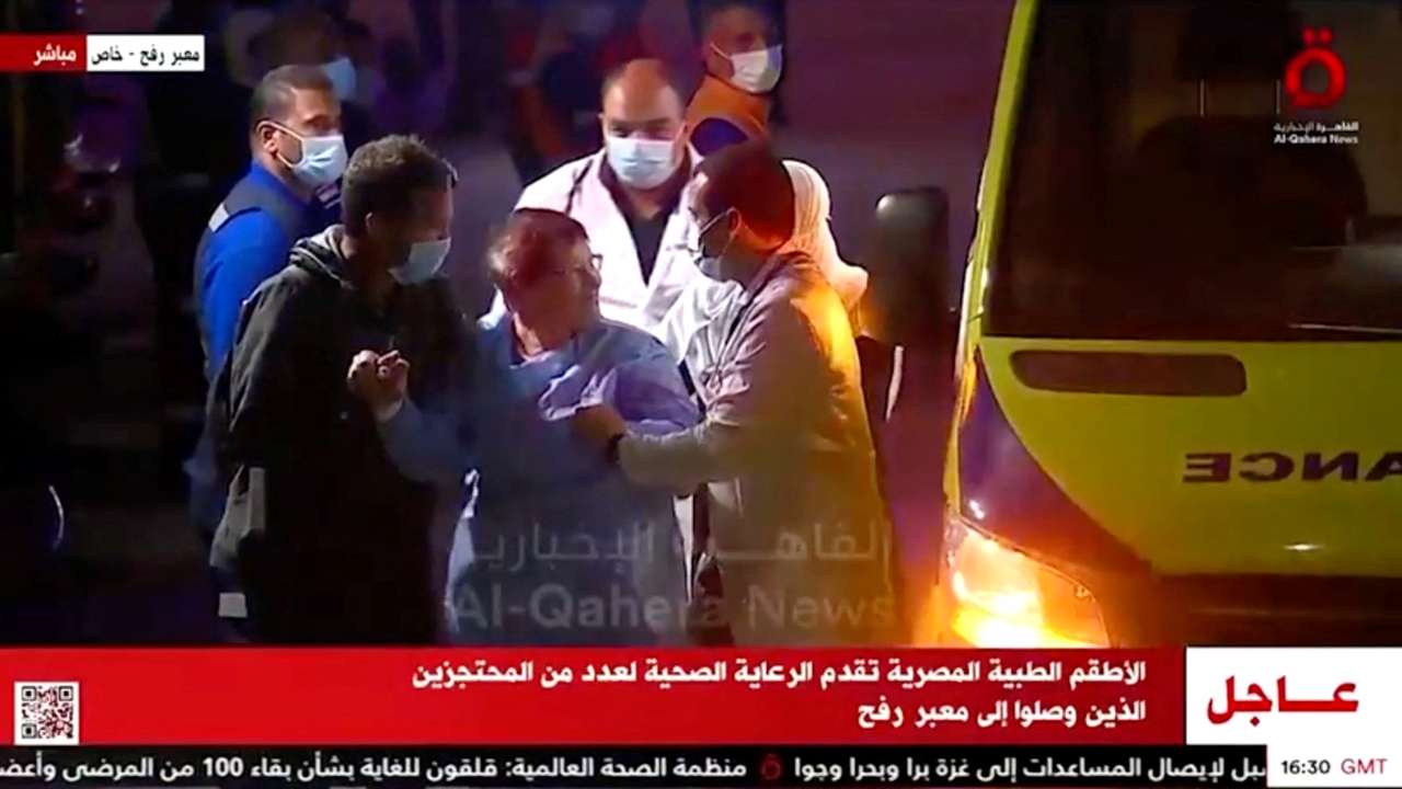 A convoy of vehicles carrying hostages abducted by Hamas militants during the October 7 attack on Israel arrives through the border crossing with Gaza