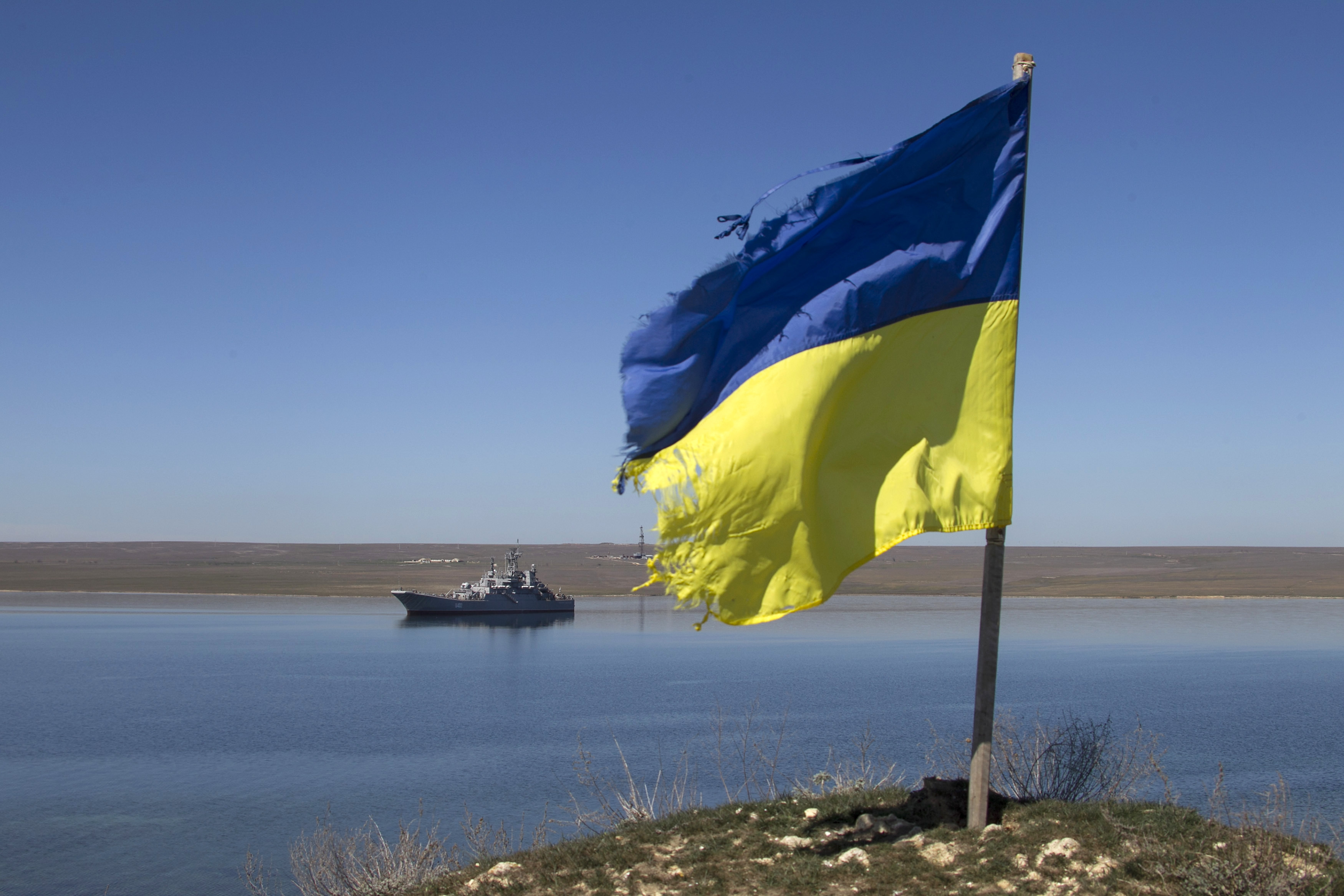 FILE PHOTO: A Ukrainian flag placed by a family member of a sailor on board the Ukrainian naval landing vessel "Konstantin Olshansky" is seen in the blockaded Donuzlav bay in Crimea