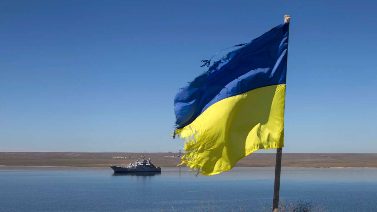 FILE PHOTO: A Ukrainian flag placed by a family member of a sailor on board the Ukrainian naval landing vessel "Konstantin Olshansky" is seen in the blockaded Donuzlav bay in Crimea