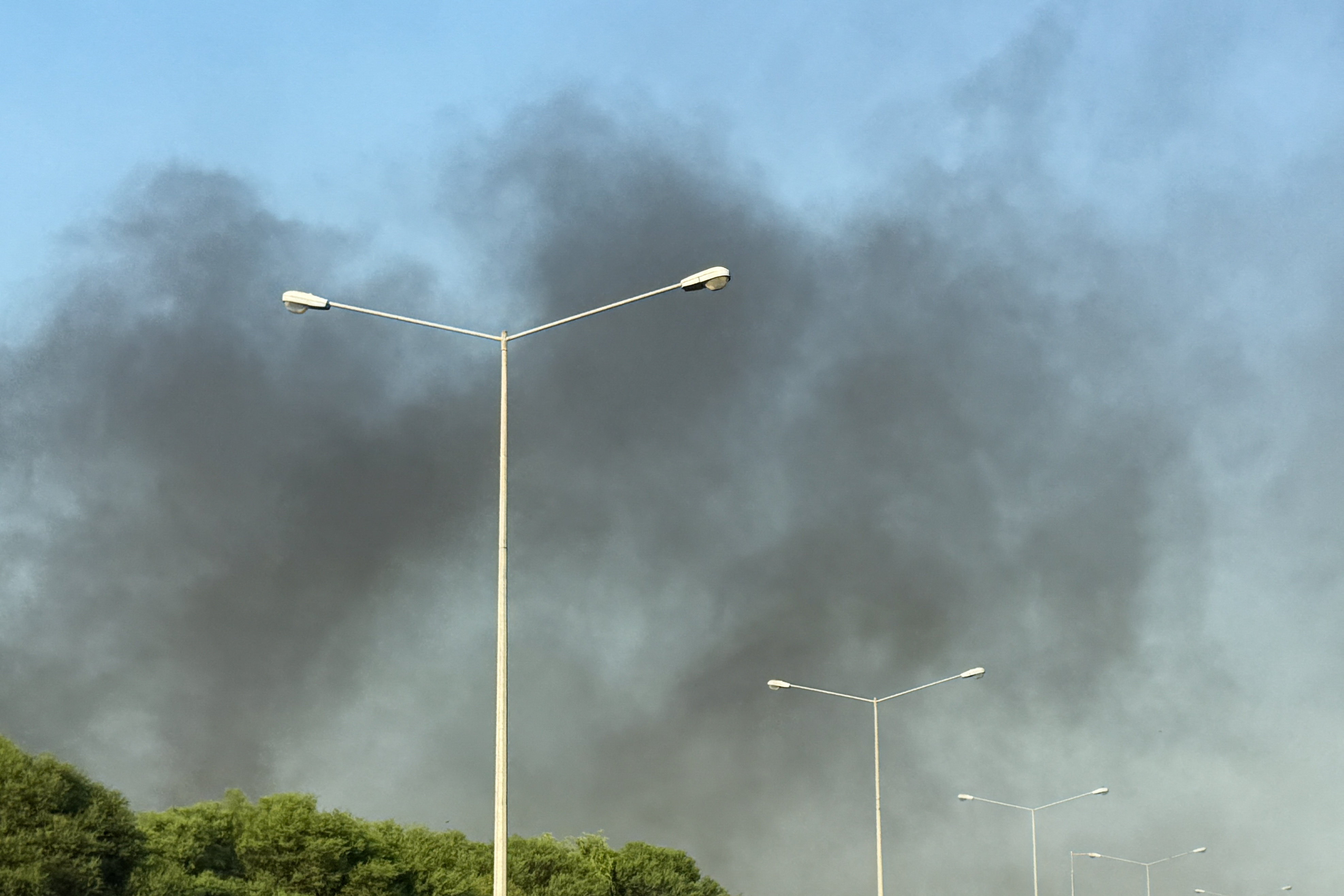 Smoke rises after several blasts were heard in Doha