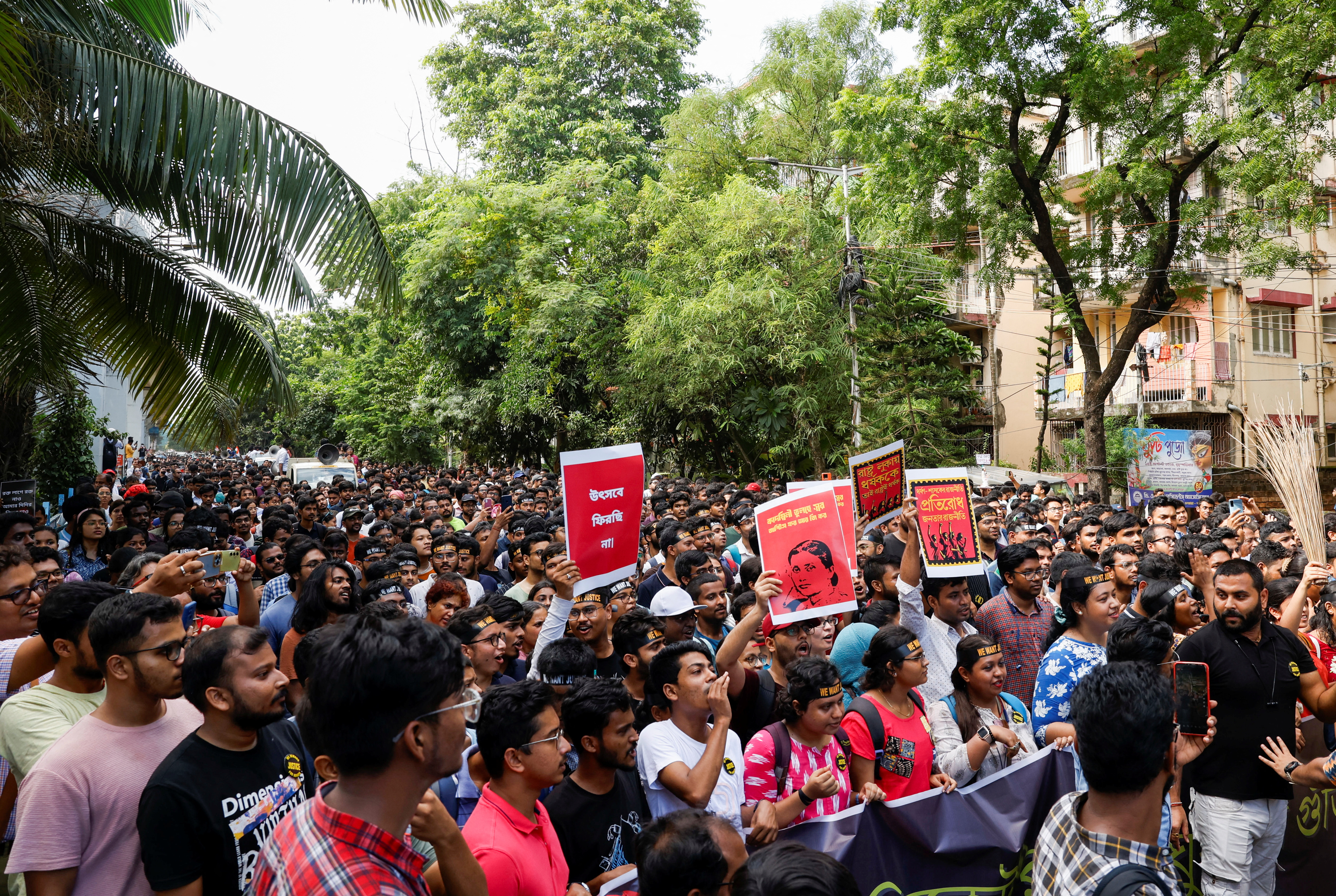 Medics march along a street during a protest condemning the rape and murder of a trainee medic at a government-run hospital, in Kolkata