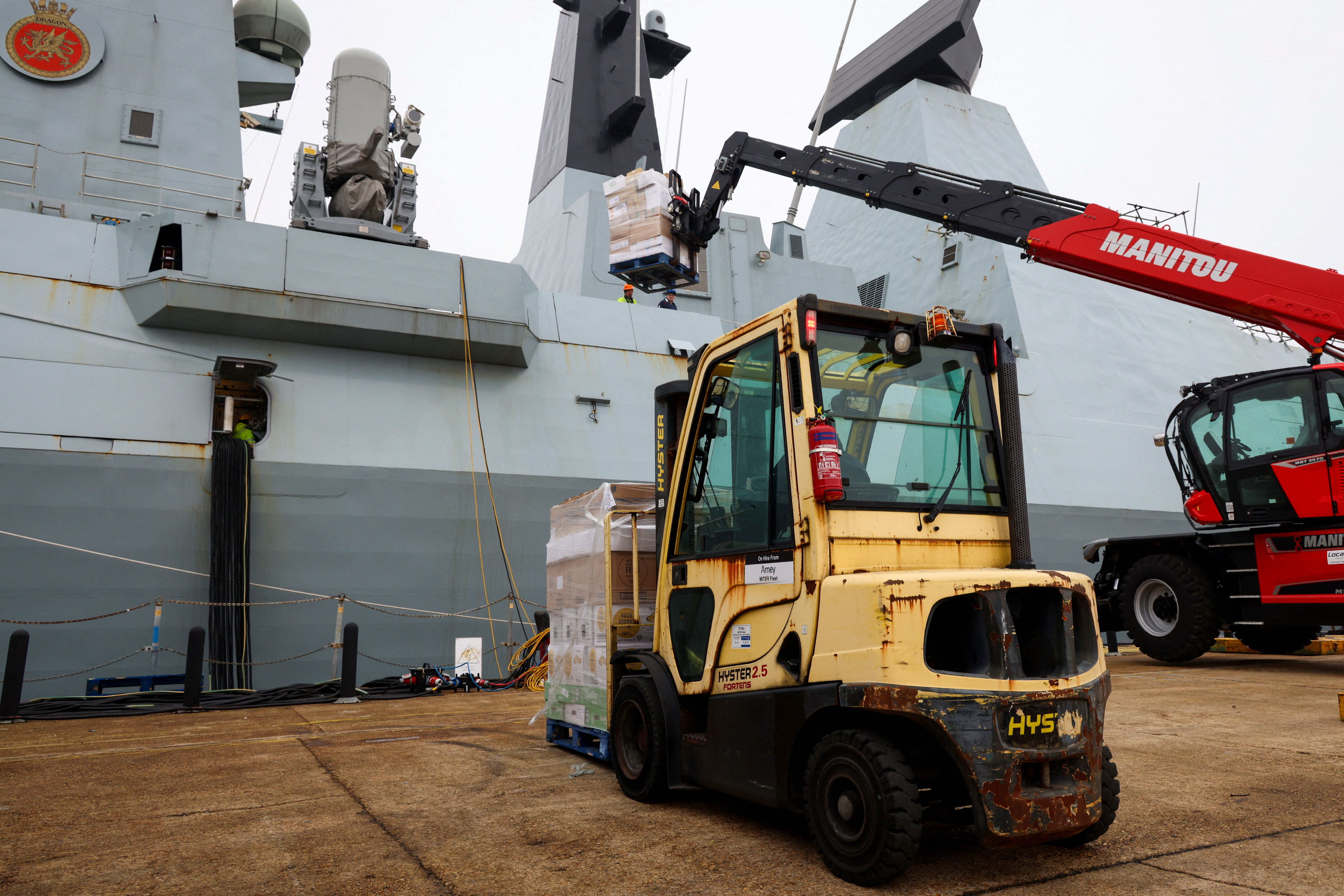 Supplies are loaded on HMS Dragon as it prepares to deploy to the Mediterranean, in Portsmouth