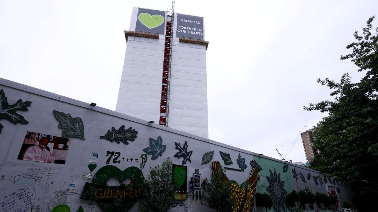 FILE PHOTO: Covered remains of Grenfell Tower seen behind a wall of condolences