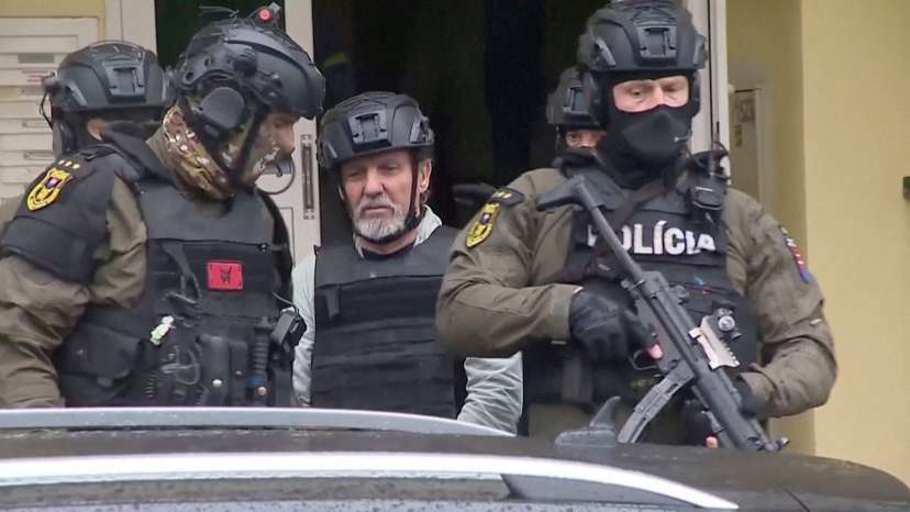 Handout footage shows police officers escorting suspect in attack on Slovak PM, in Levice
