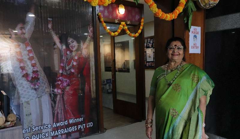 Vanaja Rao, owner of a matchmaking agency, poses for a picture in front of her office, in Hyderabad