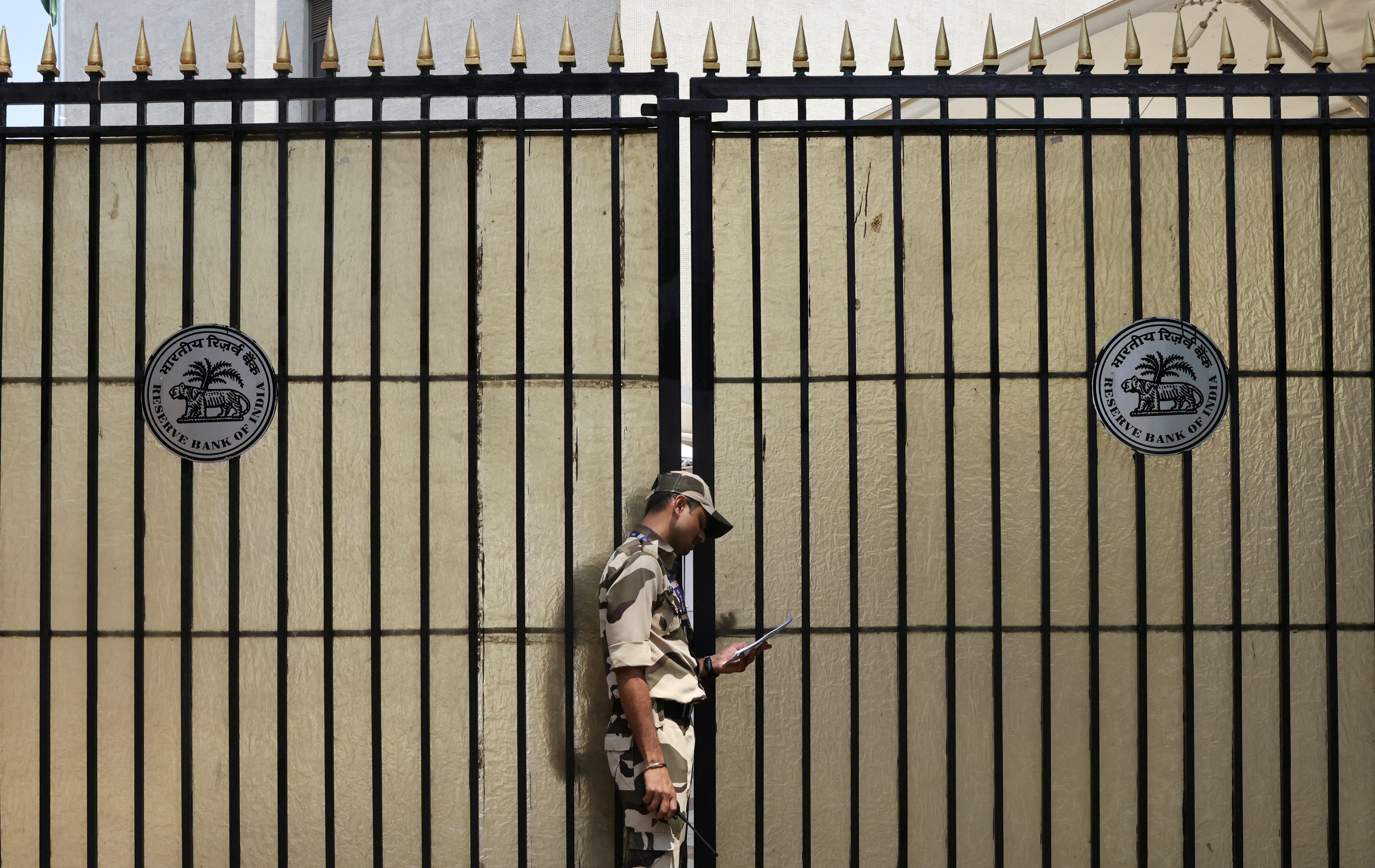 A guard stands outside the gate of the Reserve Bank of India (RBI) headquarters in Mumbai