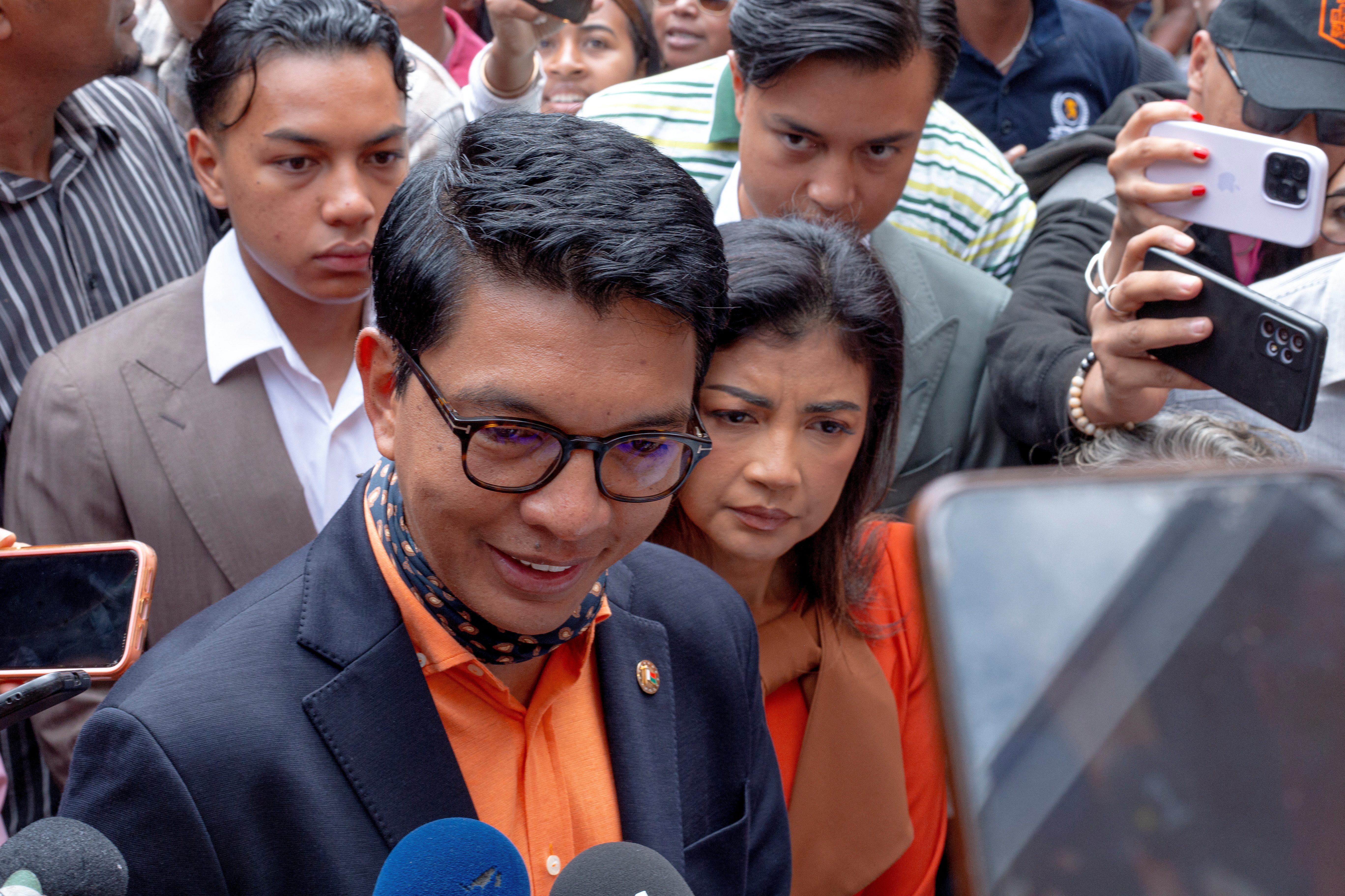 Madagascar's President and a presidential candidate Andry Rajoelina flanked by his wife Mialy Rajoelina as he arrives to cast his ballot at a polling station, during the presidential election in Ambatobe