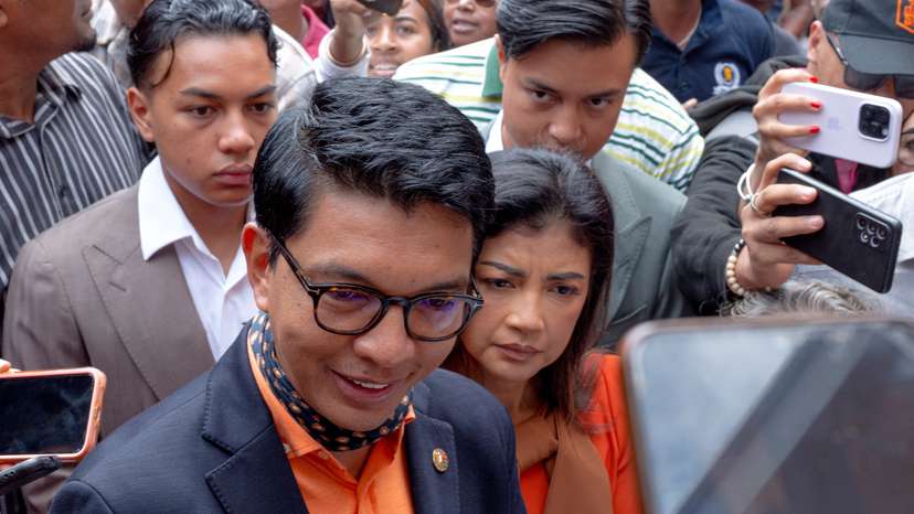 Madagascar's President and a presidential candidate Andry Rajoelina flanked by his wife Mialy Rajoelina as he arrives to cast his ballot at a polling station, during the presidential election in Ambatobe