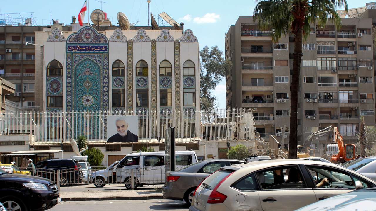 Vehicles drive near the Iranian embassy in Damascus