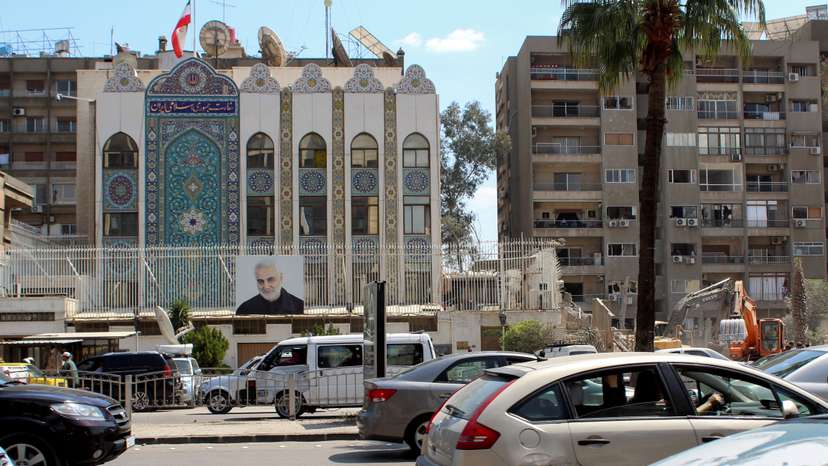 Vehicles drive near the Iranian embassy in Damascus
