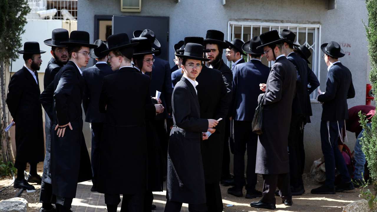 Ultra-Orthodox Jews line up at an Israeli draft office to process their exemptions from mandatory military service at a recruitment base in Kiryat Ono