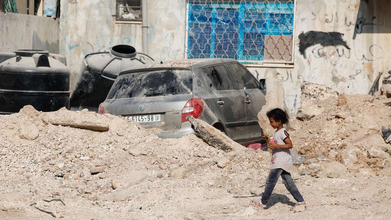 Palestinians inspect the damage, following a several day long Israeli-raid, in Jenin camp