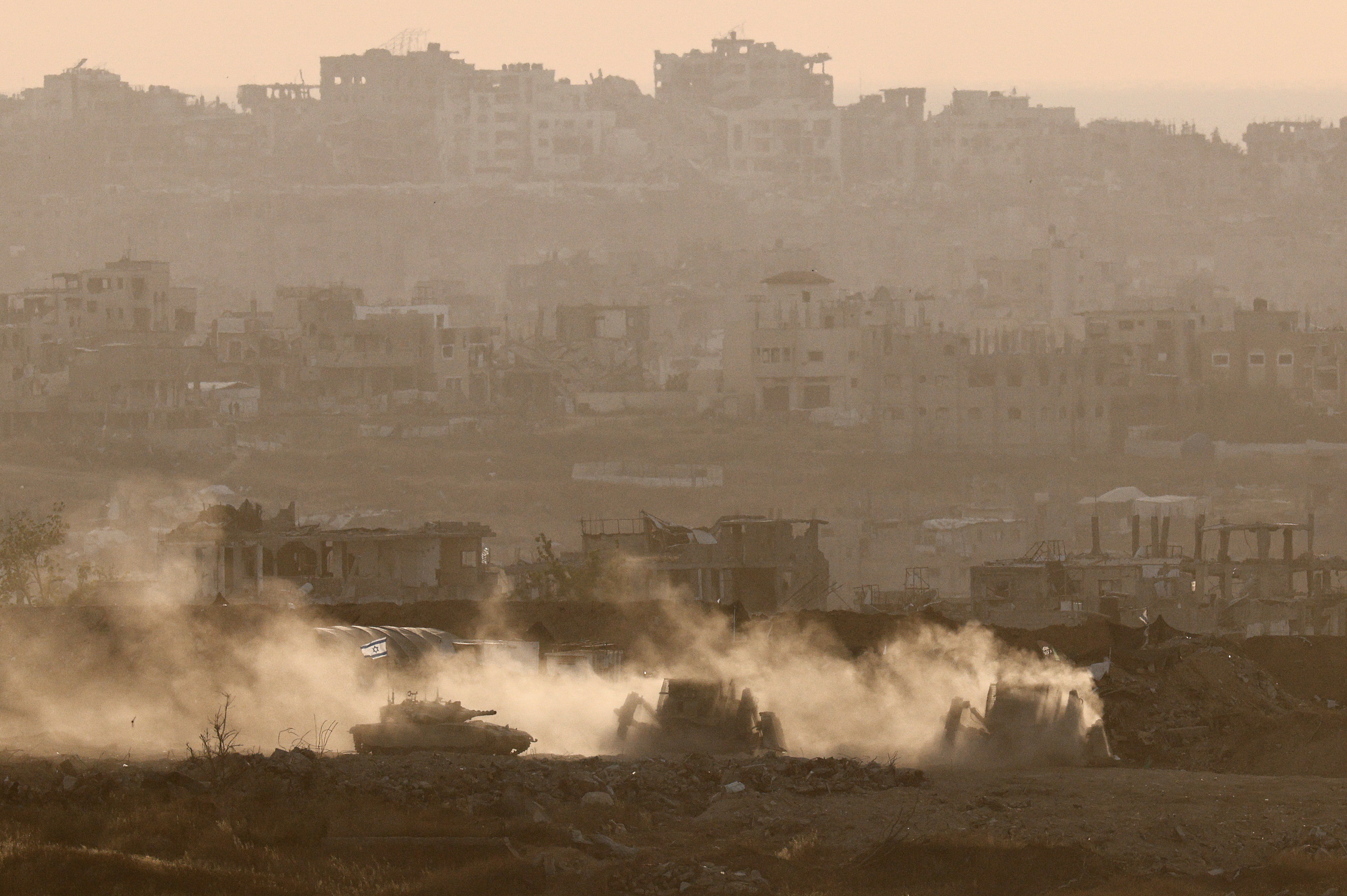 Israeli military vehicles operate in Gaza, as seen from Israel