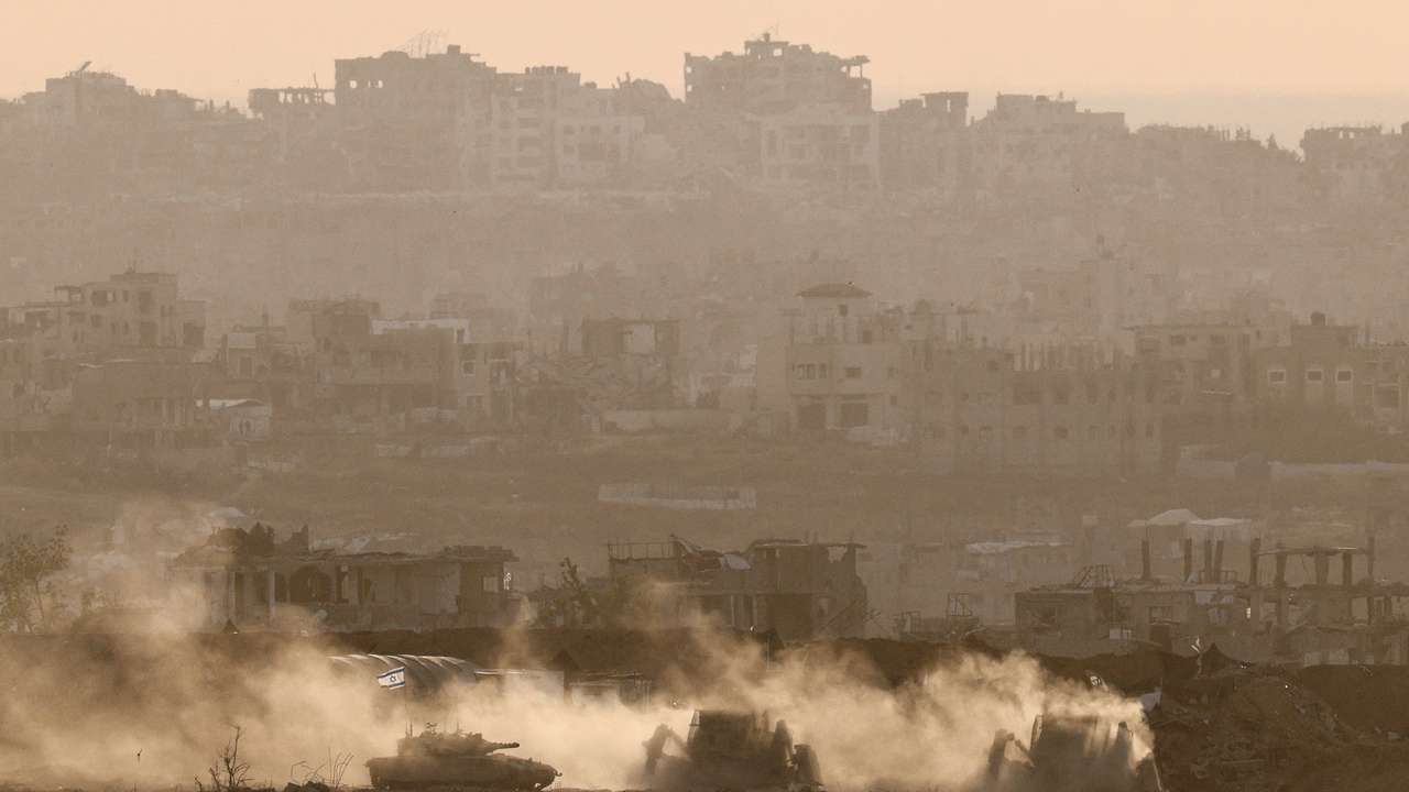 Israeli military vehicles operate in Gaza, as seen from Israel
