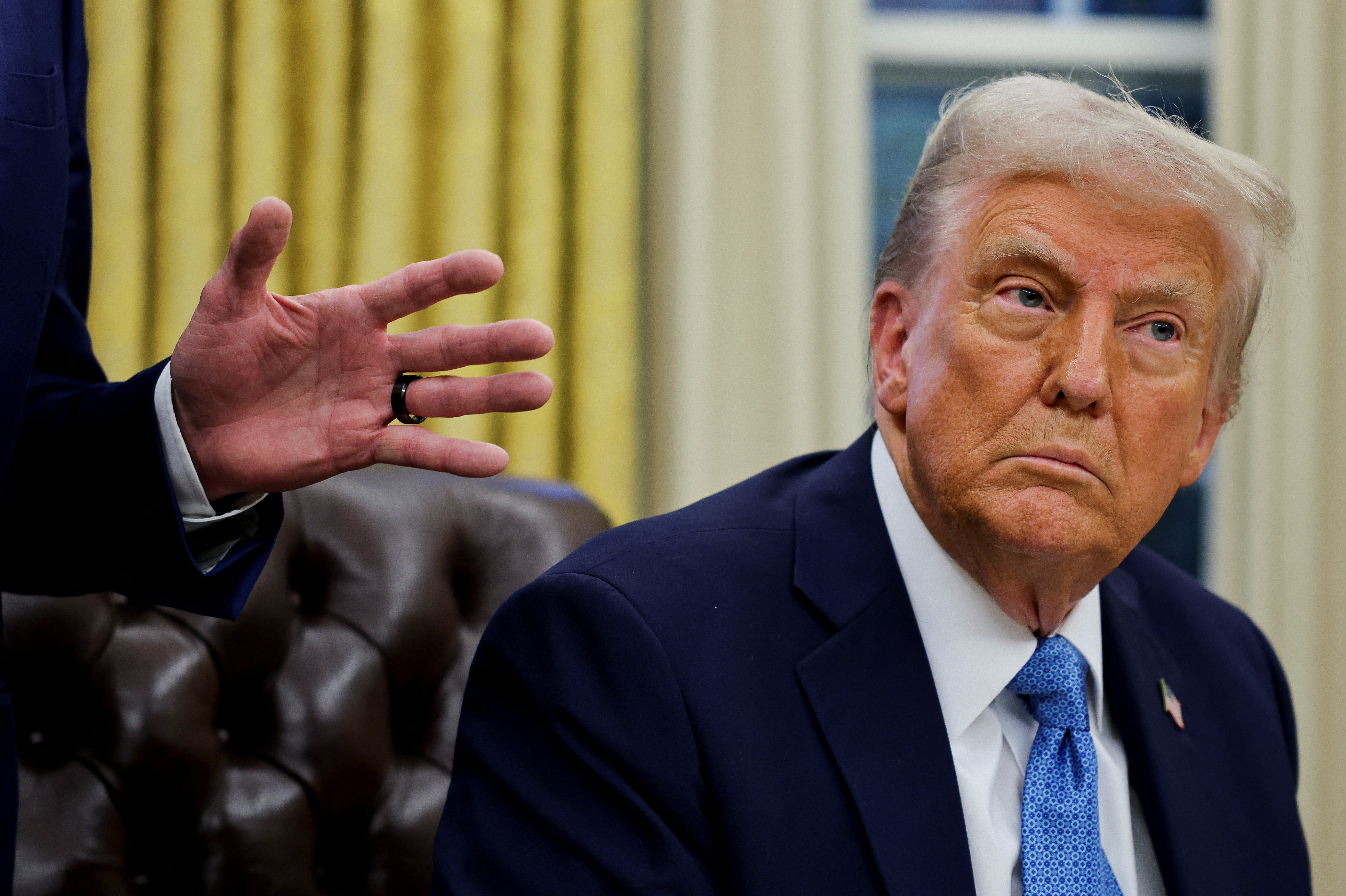 U.S. President Donald Trump signs an executive order in the Oval Office at the White House