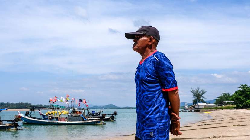 Banlue Choosin, a 2004 Indian Ocean Tsunami survivor-turned-wave watcher, looks on at a seashore in Ban Nam Khem