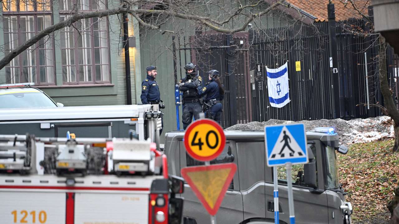 Emergency workers stand near the Israeli embassy in Stockholm