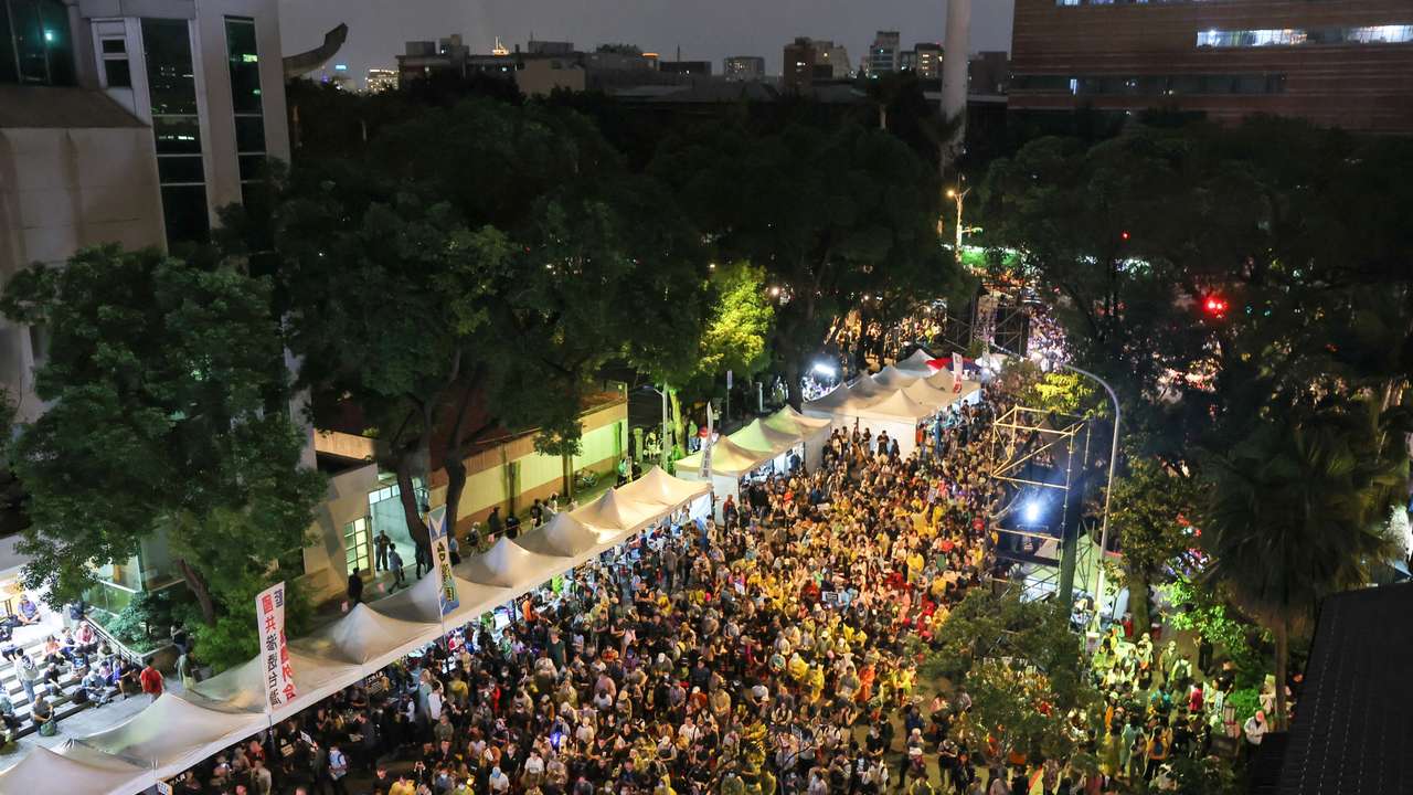 People gather outside the parliament in Taipei