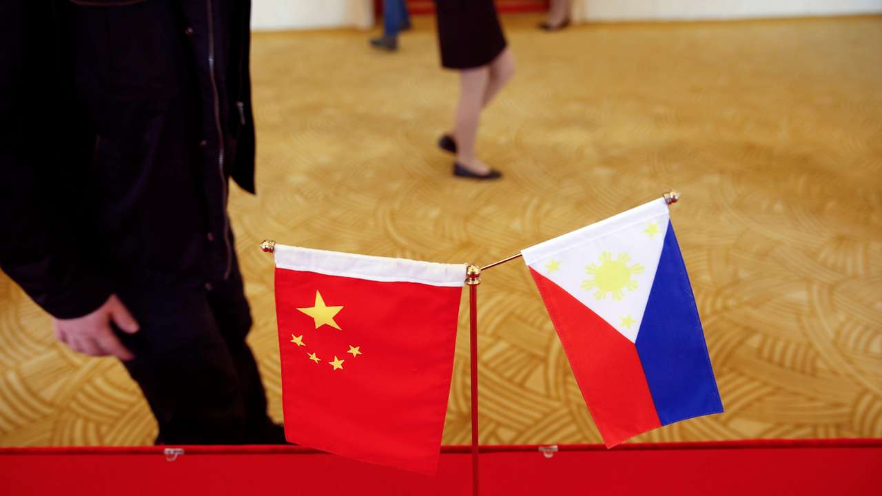 National flags are placed outside a room where Philippine Finance Secretary Carlos Dominguez and China's Commerce Minister Gao Hucheng address reporters after their meeting in Beijing