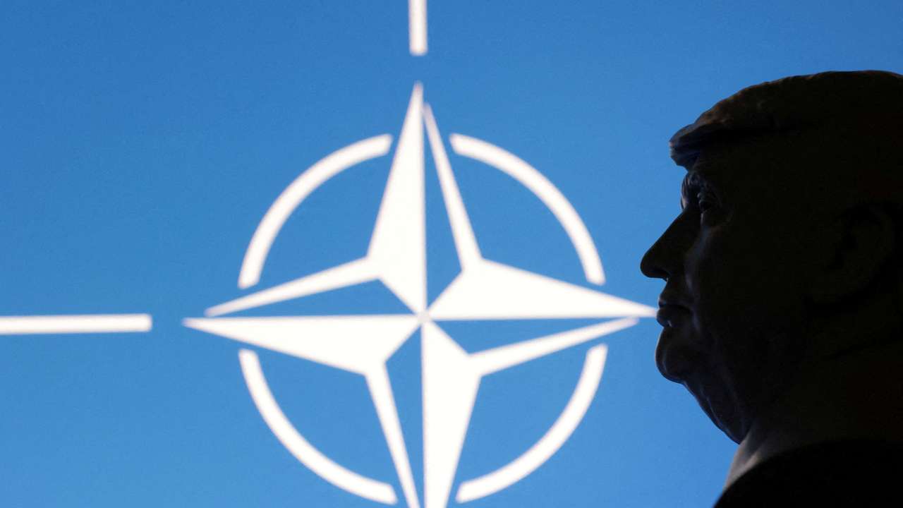 FILE PHOTO: Illustration shows 3D-printed miniature model of U.S. President Trump and NATO logo