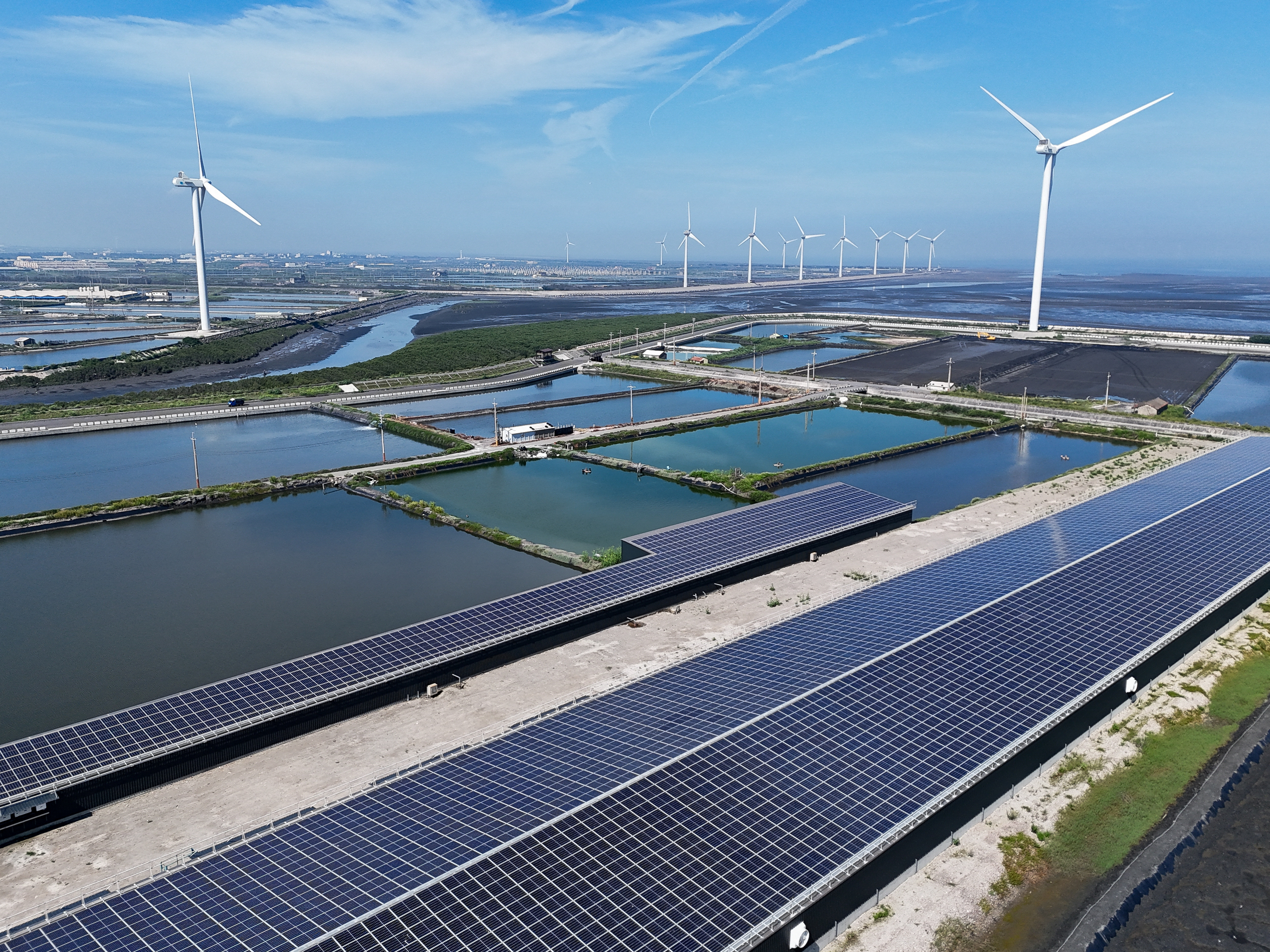 Wind turbines and solar panels are pictured in Changhua