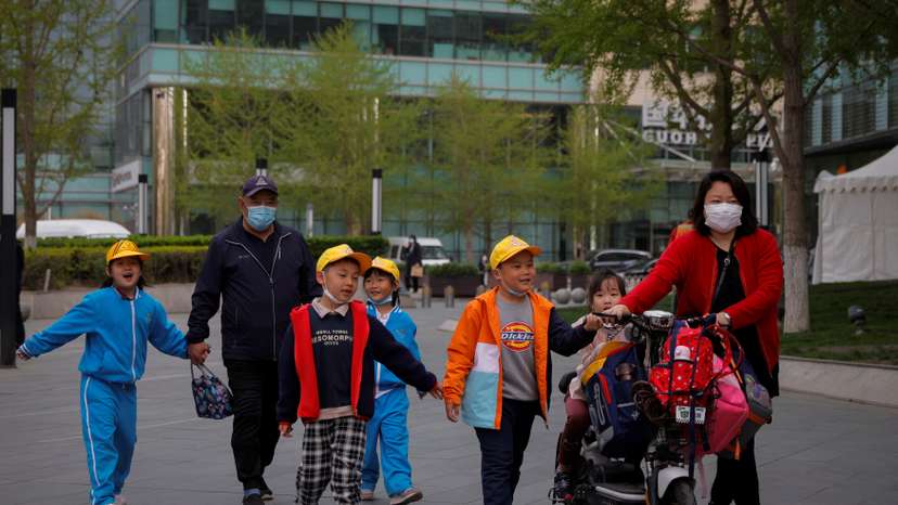 People pick up children from a school in Beijing