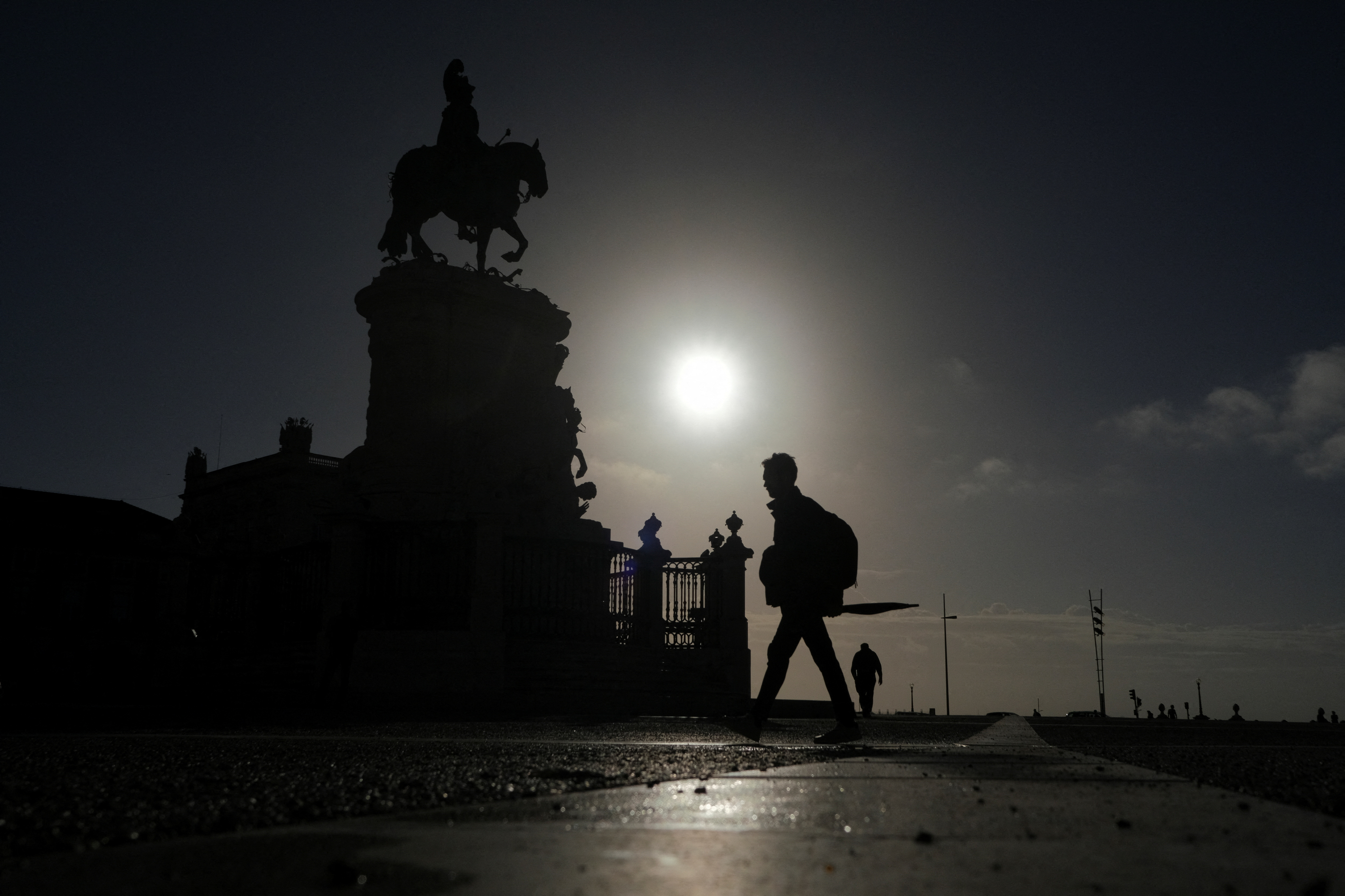 People walk early in the morning in Terreiro do Paco, Lisbon