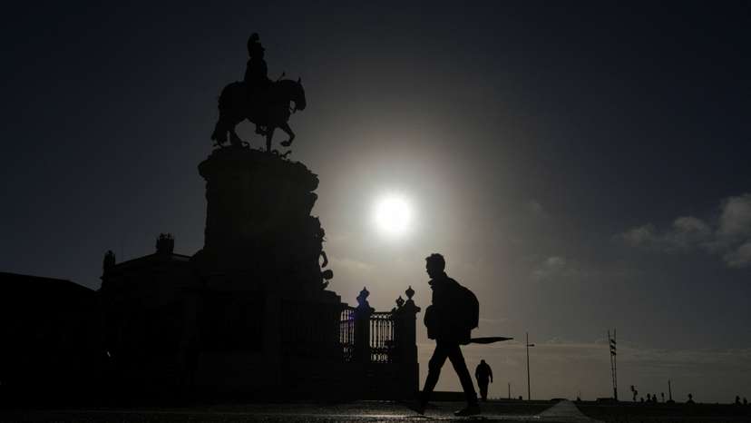 People walk early in the morning in Terreiro do Paco, Lisbon