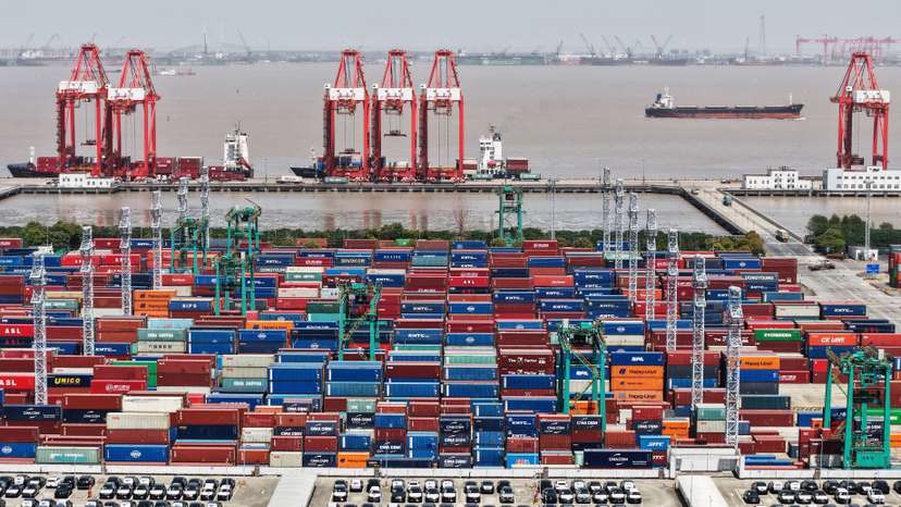 Drone view shows electric vehicles (EV) for export and containers sitting at a port in Shanghai