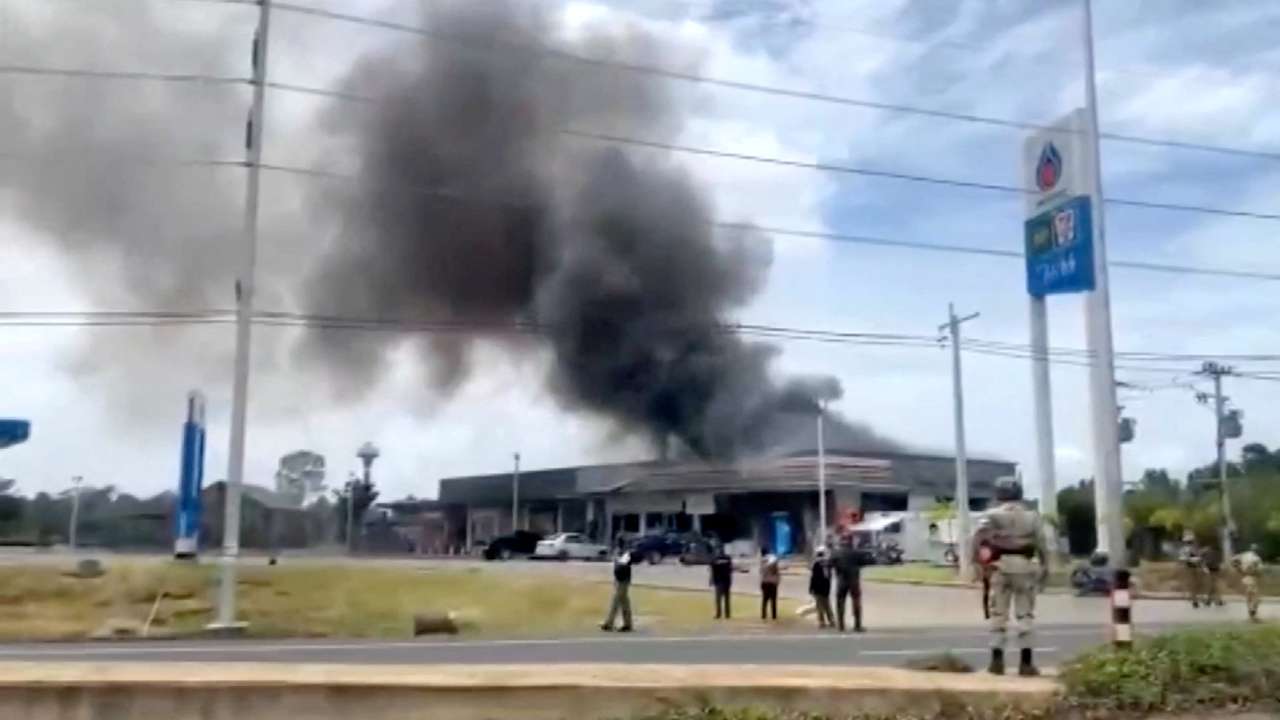 Smoke rises from a convenience store at a gas station, amid the clashes between Thailand and Cambodia, in Kantharalak district