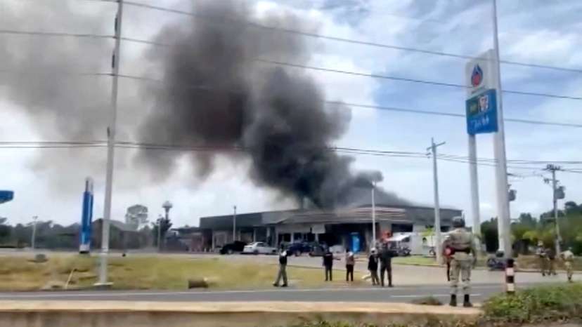Smoke rises from a convenience store at a gas station, amid the clashes between Thailand and Cambodia, in Kantharalak district