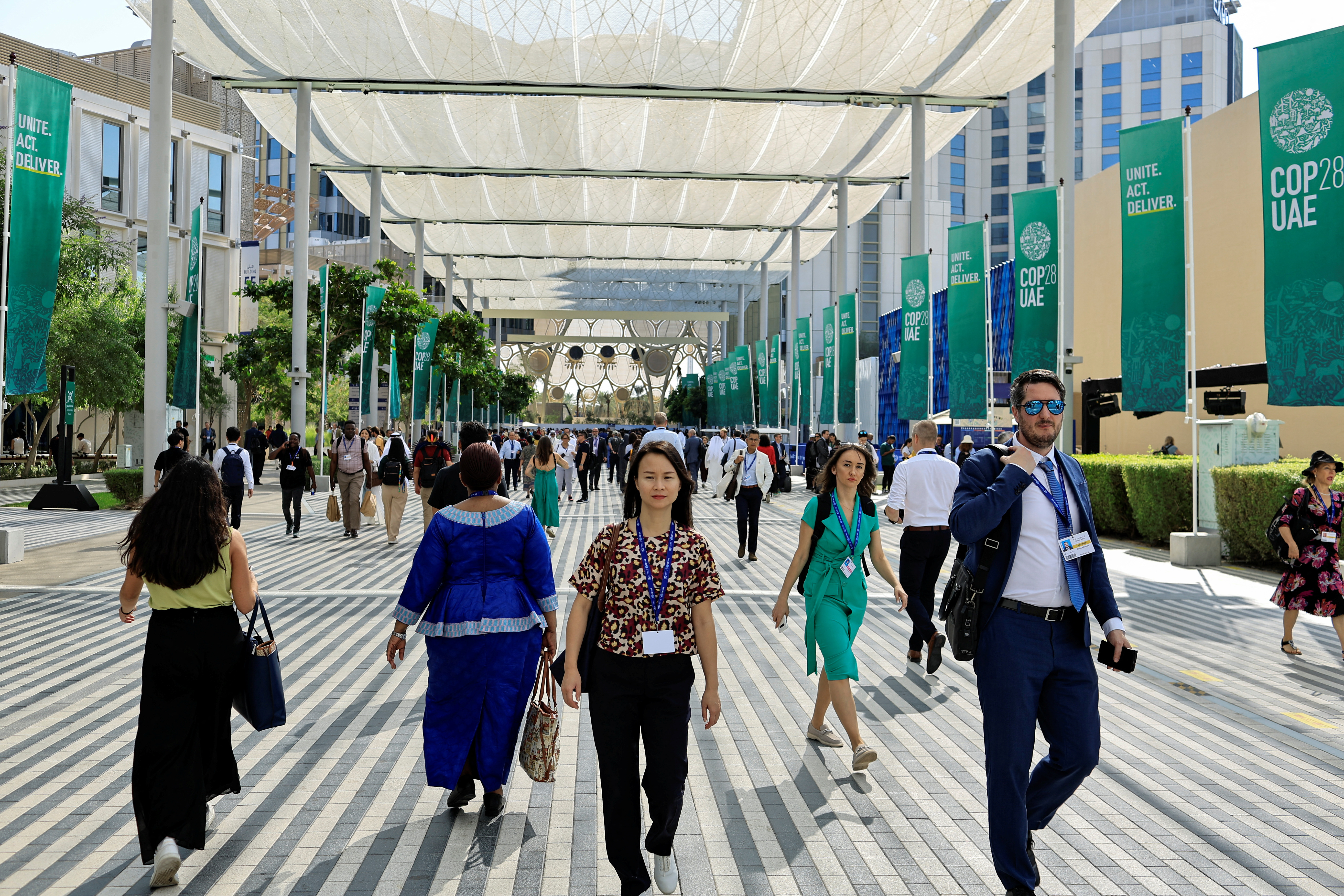 Delegates walk at the Dubai's Expo City during the United Nations Climate Change Conference (COP28) in Dubai