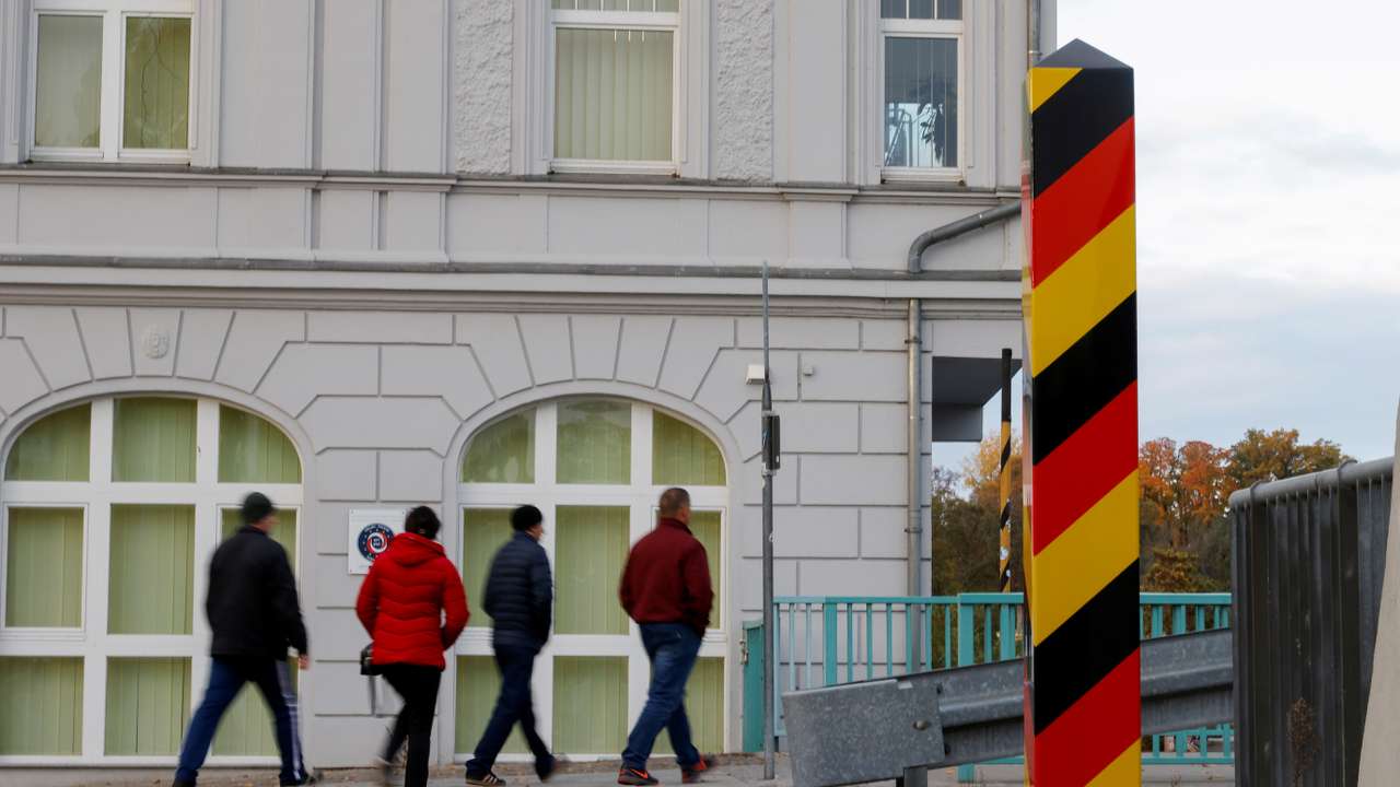 People cross the border between Germany and Poland, in Guben