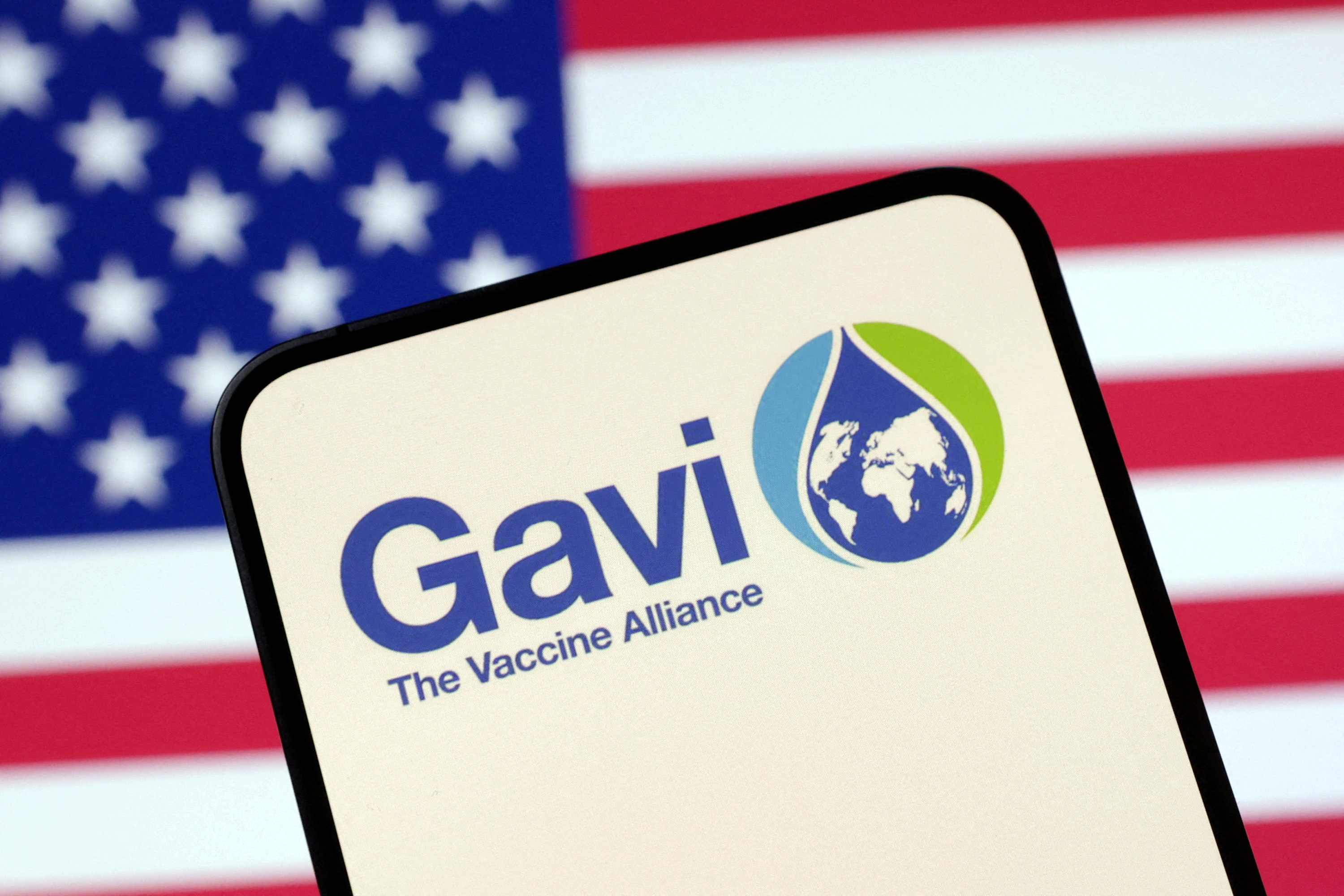 FILE PHOTO: Illustration shows The Vaccine Alliance (GAVI) logo and U.S. flag