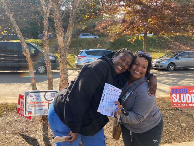 Shenekia Daniels, a teacher, and Tiara Talford, a corporate trainer, pose outside of an early voting location in Asheville