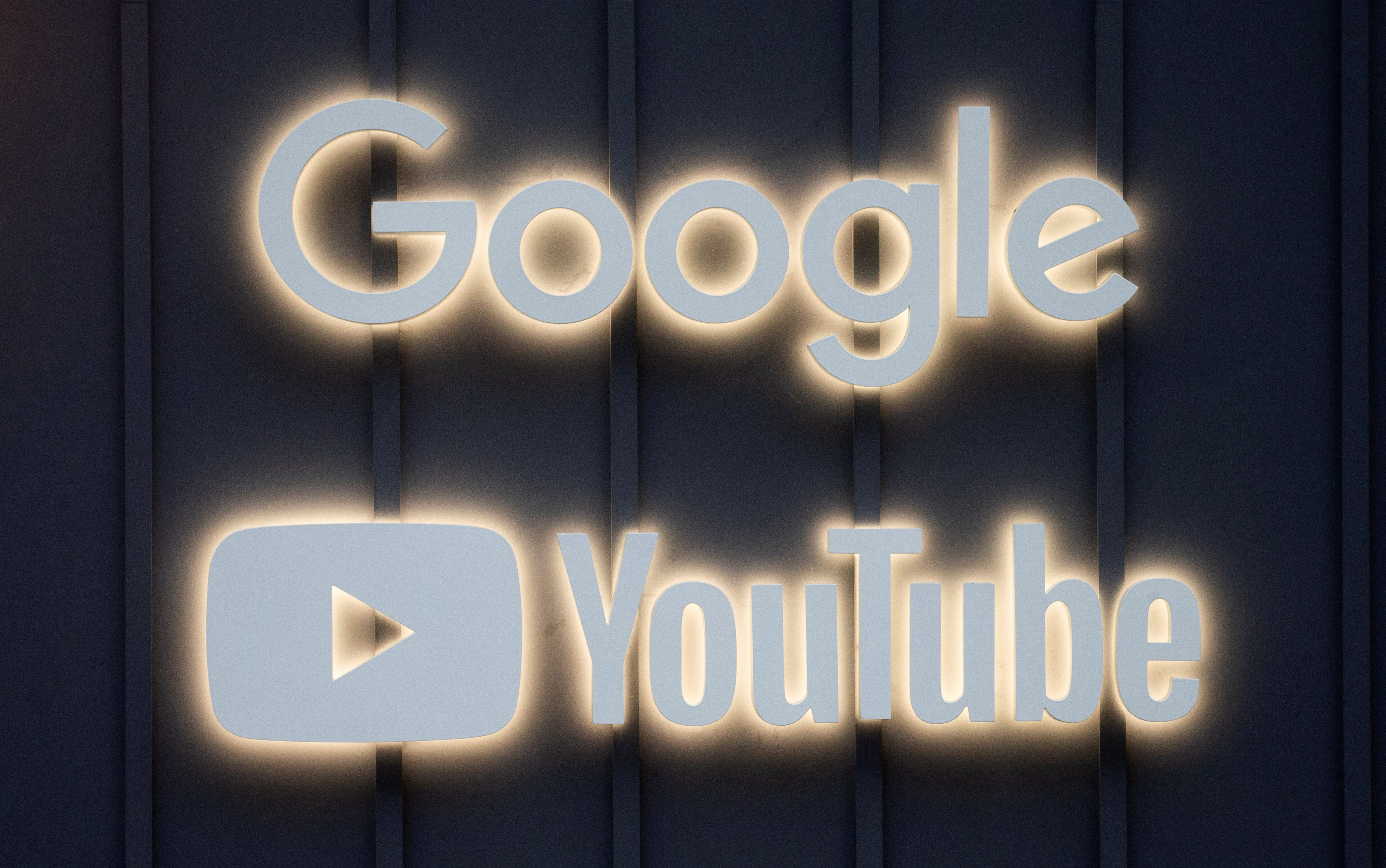 FILE PHOTO: The logos of Google and YouTube are seen in Davos