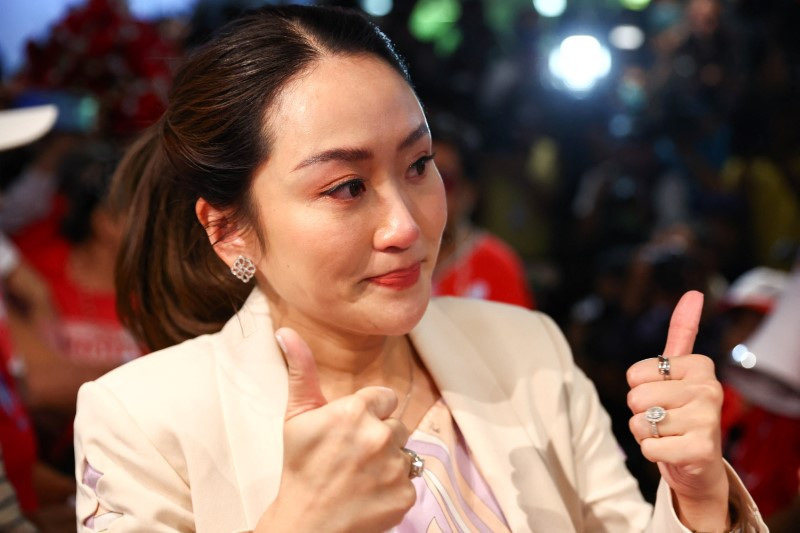 Pheu Thai's prime ministerial candidate, Paetongtarn Shinawatra, attends a birthday celebration held by red shirt supporters, a day ahead of her father, former Prime Minister Thaksin Shinawatra, coming home from self-exile in Bangkok