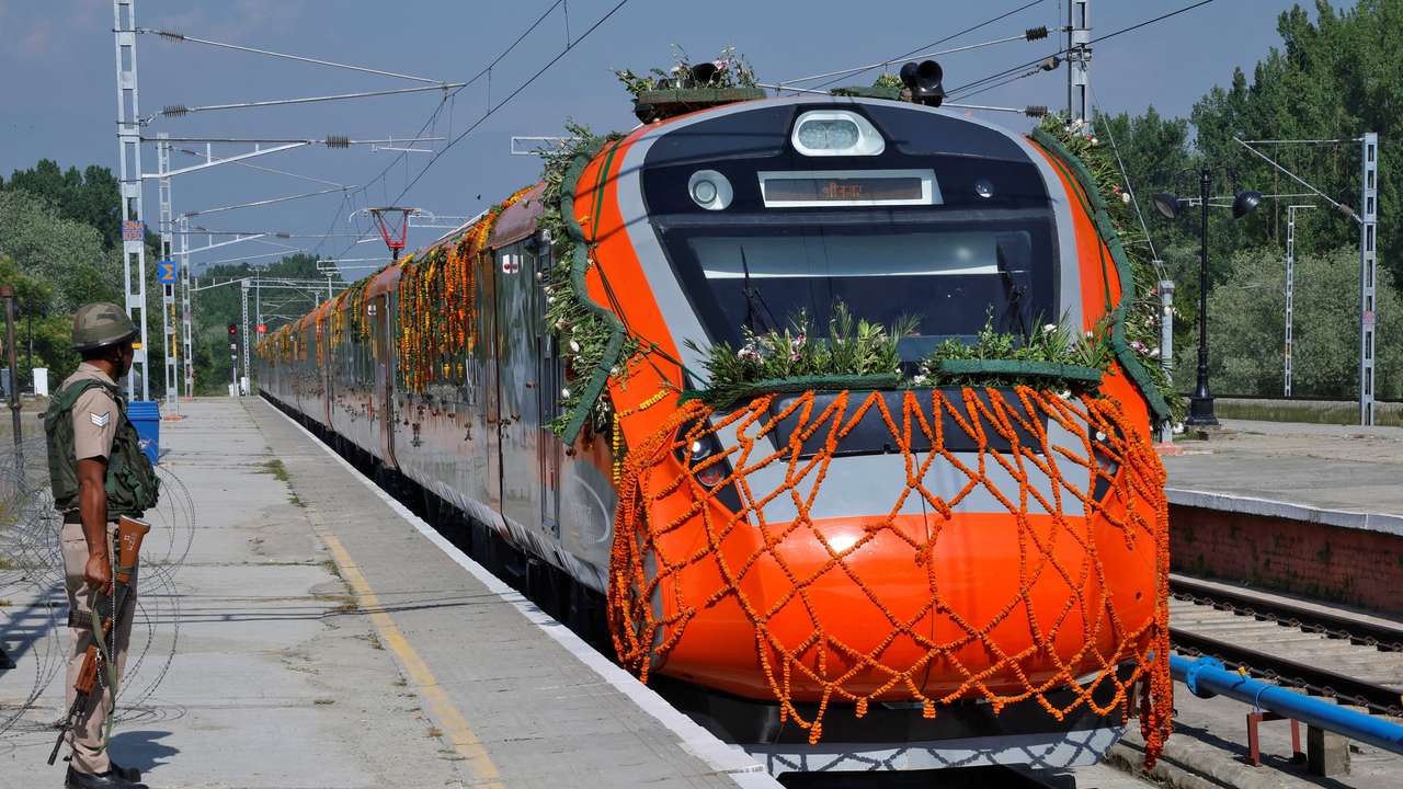 A security force personnel stands guard as India's high-speed train "Vande Bharat Express" arrives at Srinagar railway station