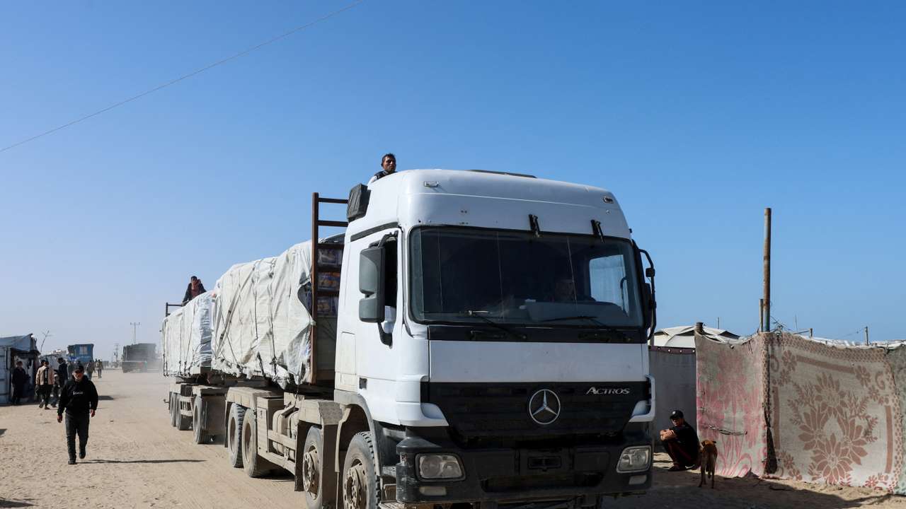 Aid trucks move on a road after entering Gaza through the Kerem Shalom crossing, in Rafah